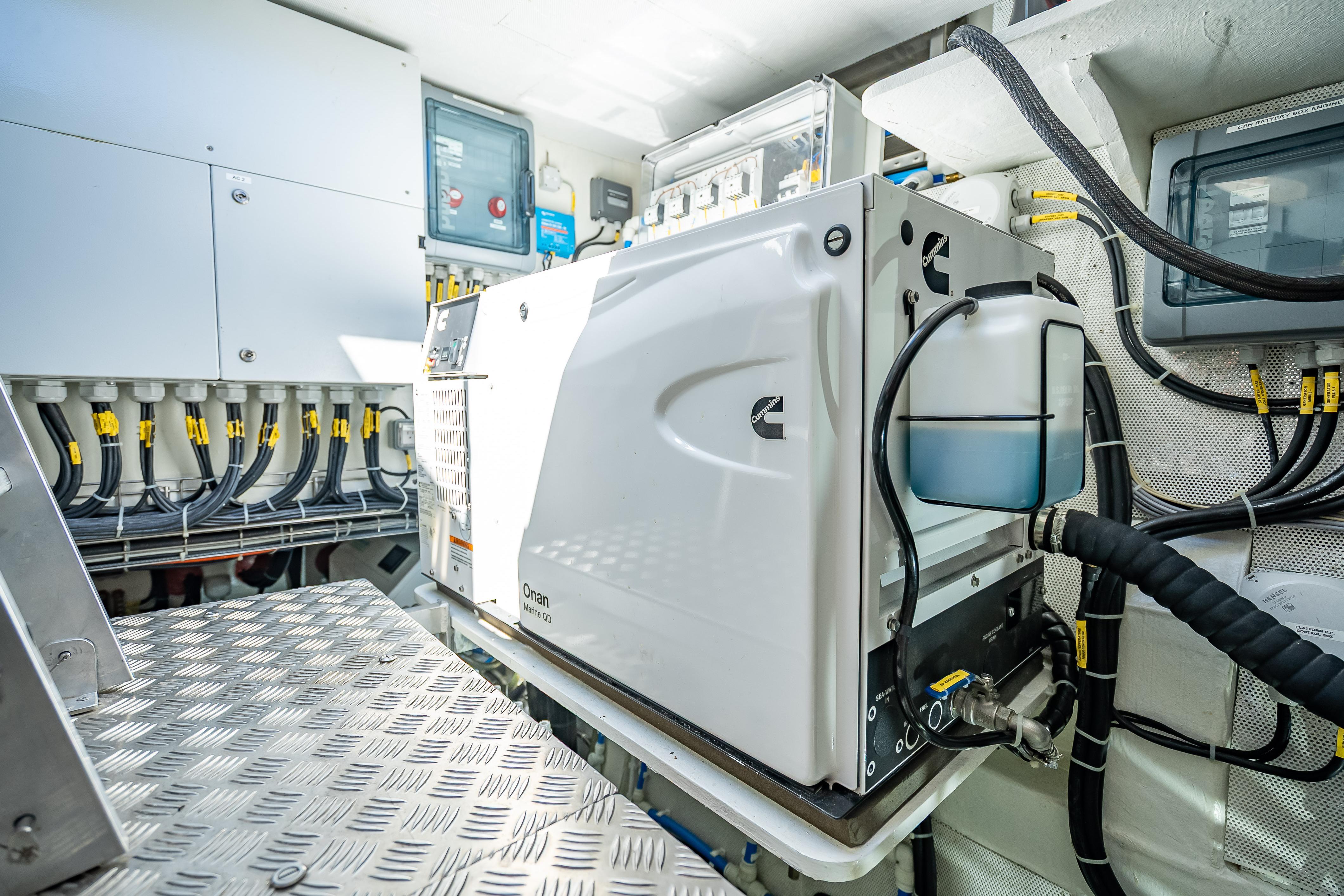 Engine room of 2026 Sunreef 60 Power yacht with Cummins generator and wiring.