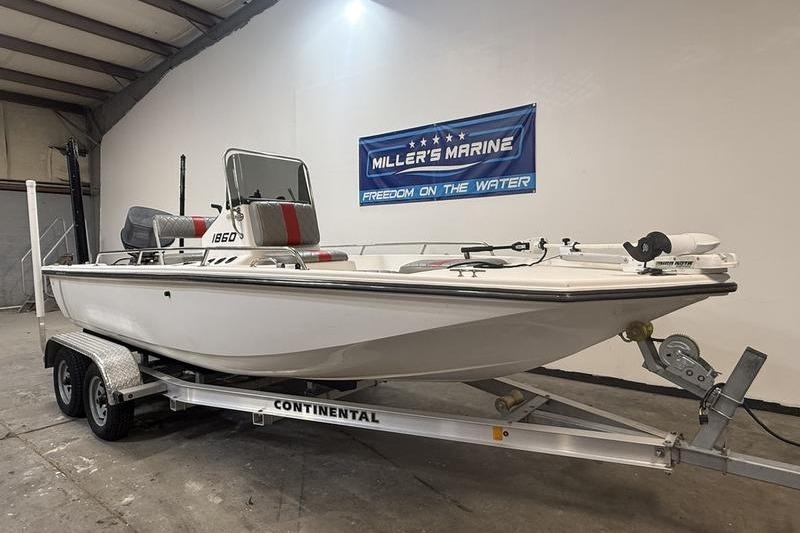 1996 Century 1800 Center Console boat on Continental trailer in showroom.