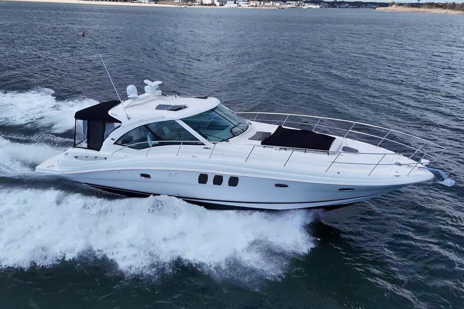2008 Sea Ray 480 Sundancer cruising on open water, showcasing sleek design and performance.