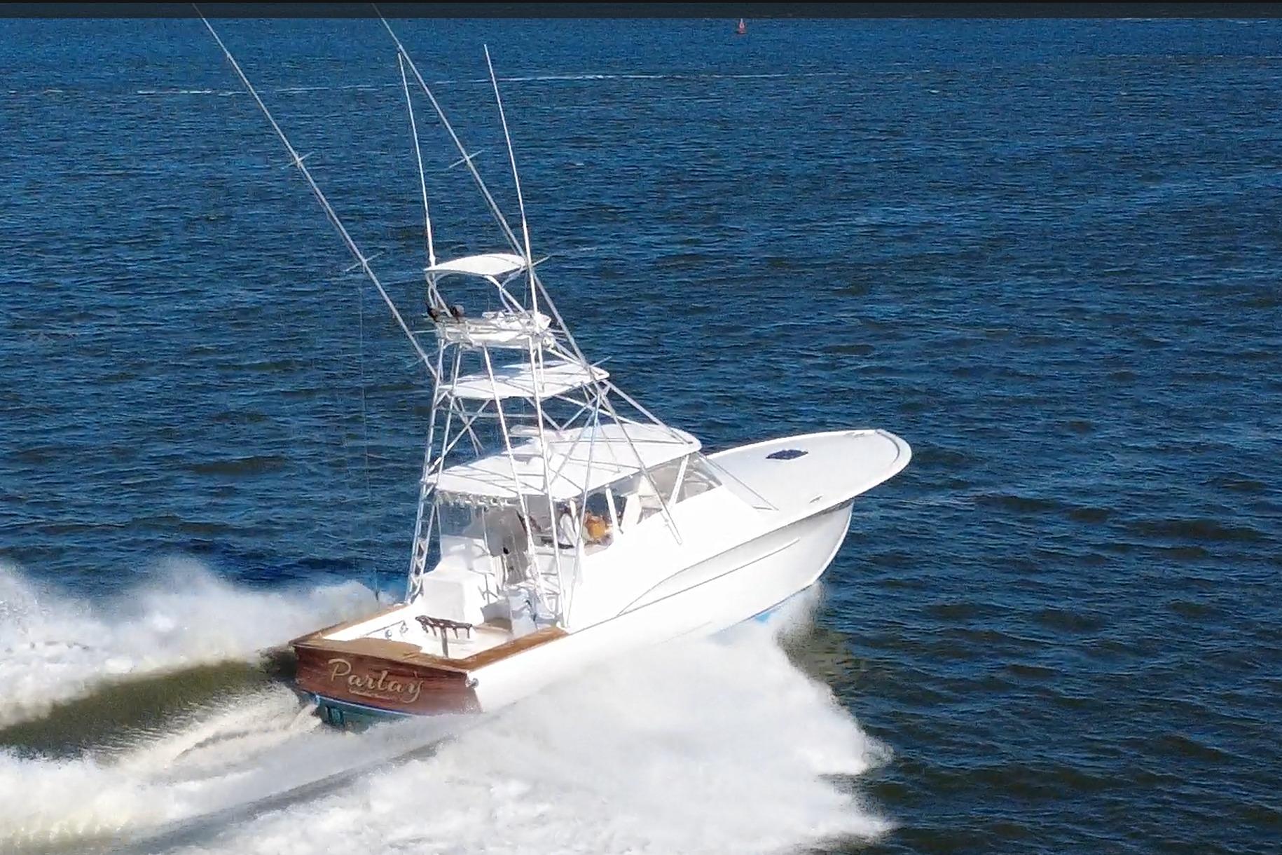 2006 Custom Carolina Heritage Express boat cruising on open water.