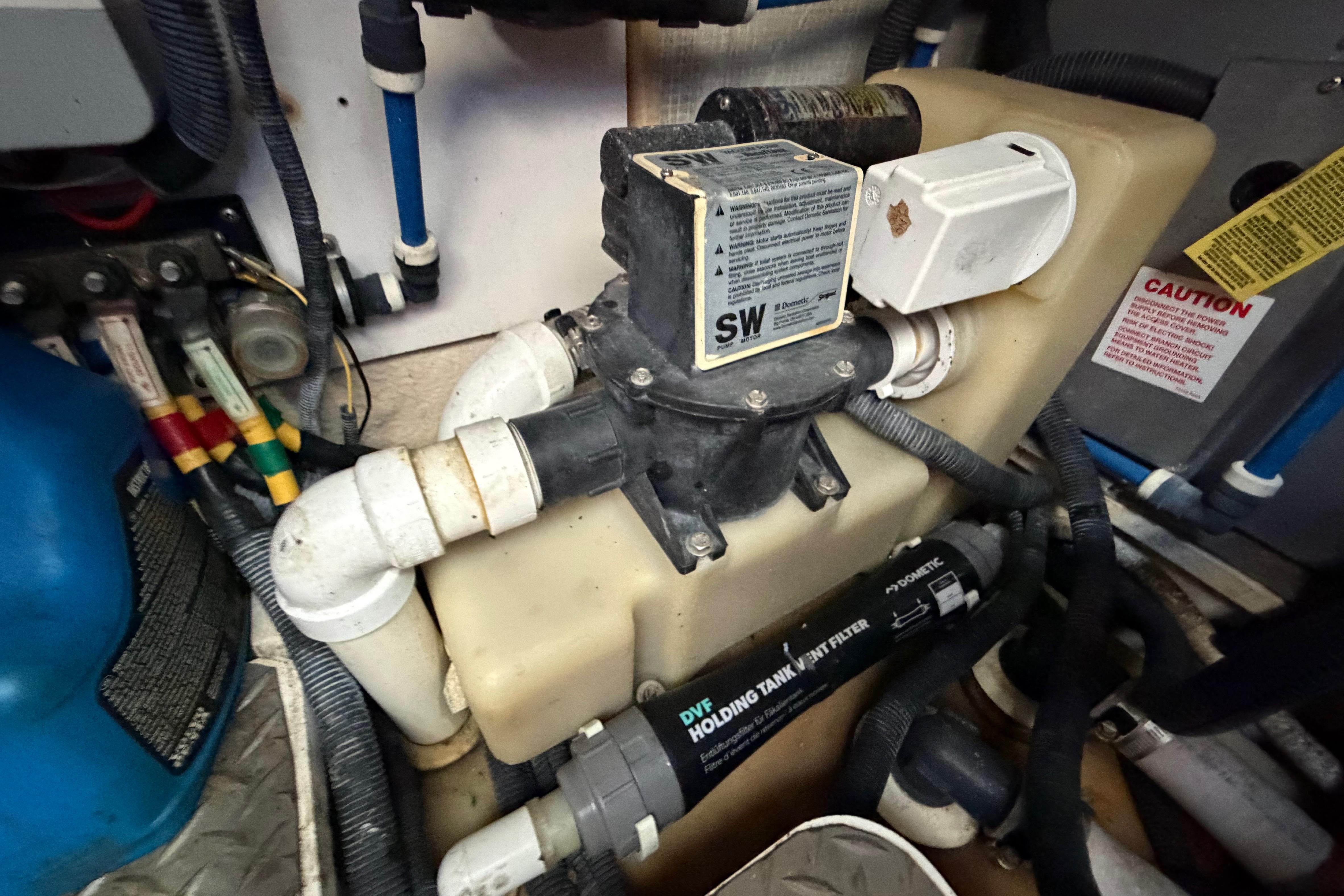 Engine room of a 2007 Monterey 350 Sport Yacht showing plumbing and filtration system.
