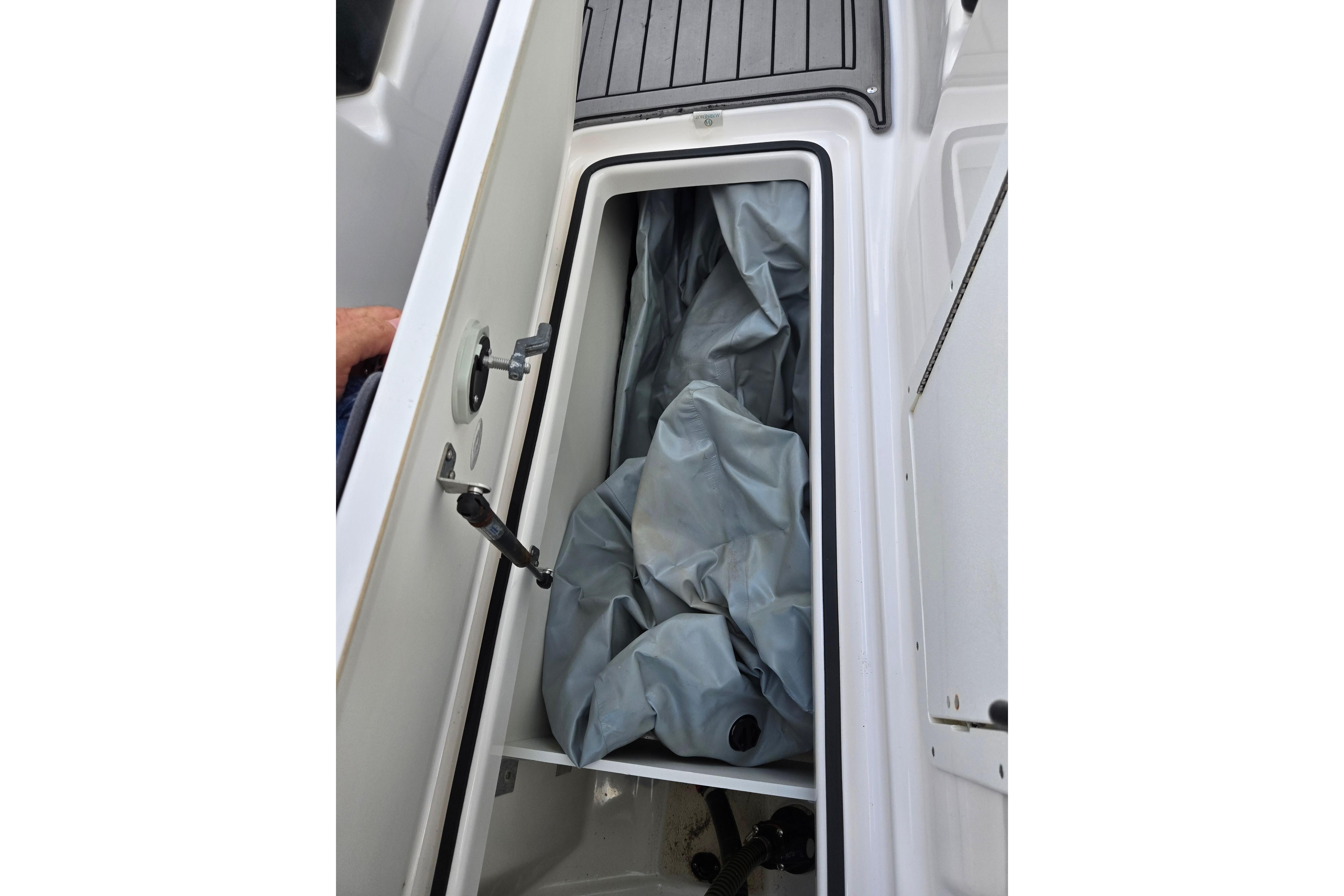 Open storage compartment on 2018 Yamaha Boats 212X, showing interior space and cover.