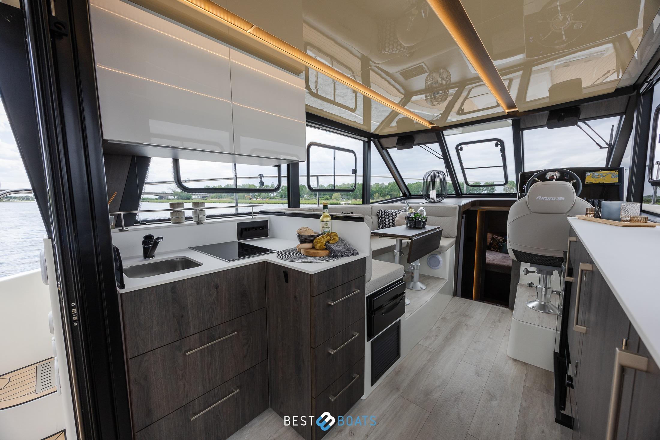 Luxurious interior of 2023 Cobra Yachts Futura 36 Premium Fly with modern kitchen and seating area.