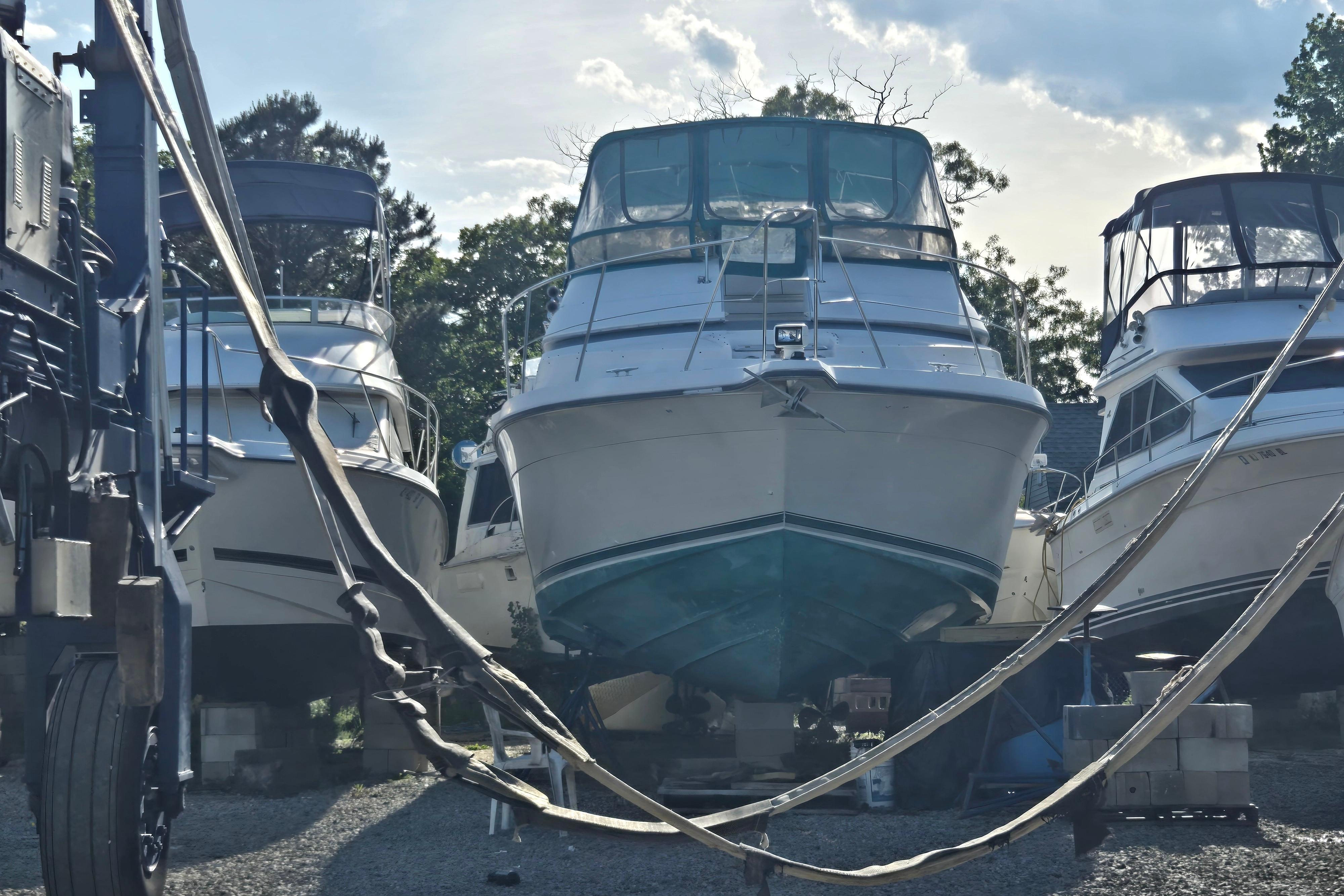 1994 Carver 380 Santego yacht in dry dock, surrounded by other boats, under a clear sky.