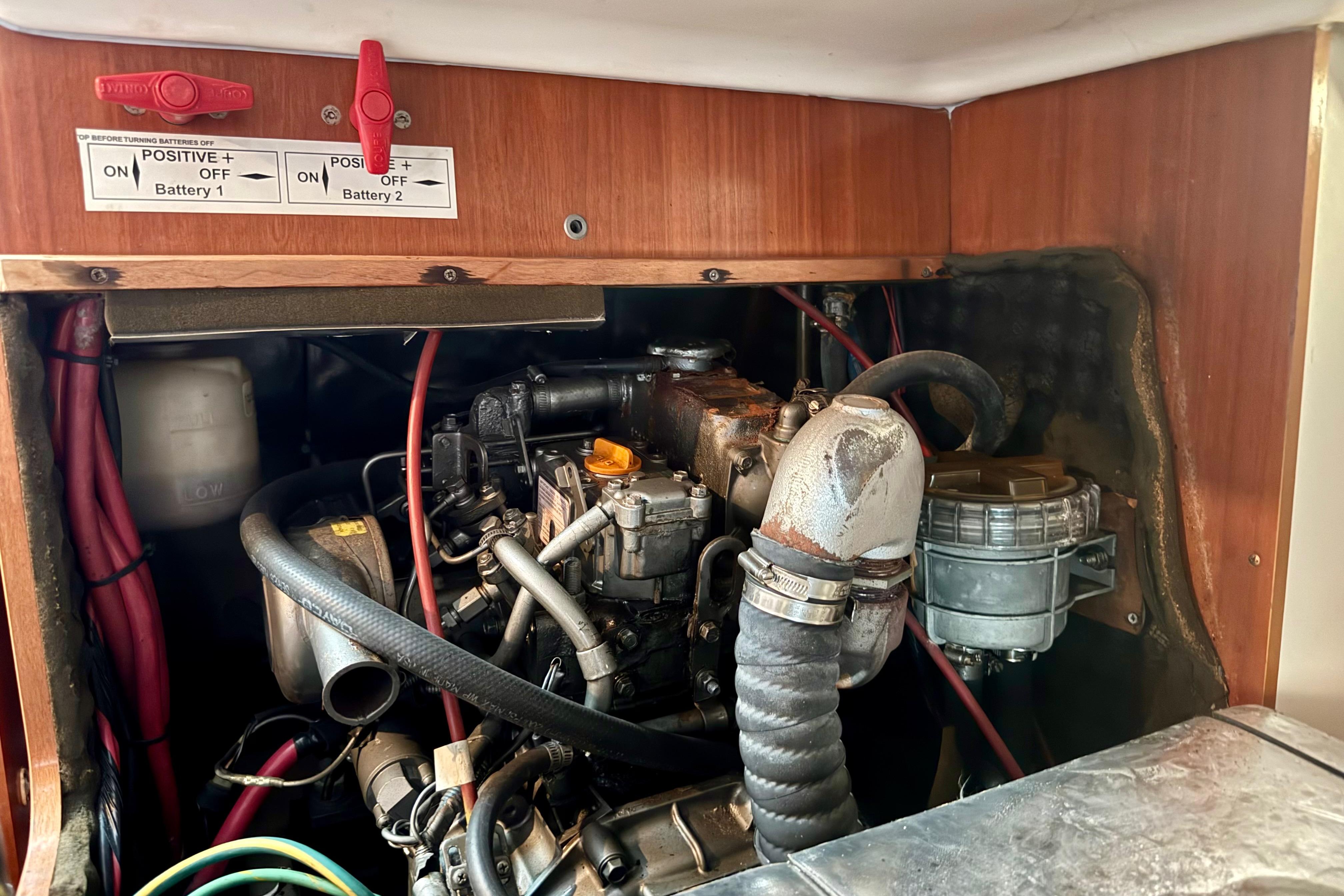Engine compartment of a 2002 Beneteau Oceanis Clipper 311 sailboat, showing battery switches.