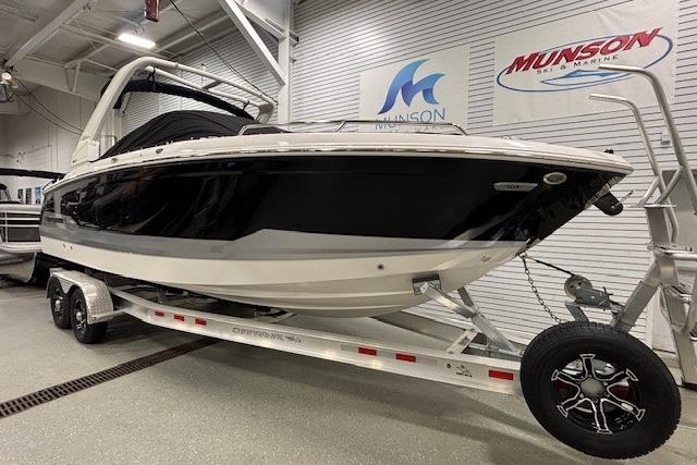 2026 Chaparral SSX 8 boat on trailer in showroom, Munson Marine signage visible.