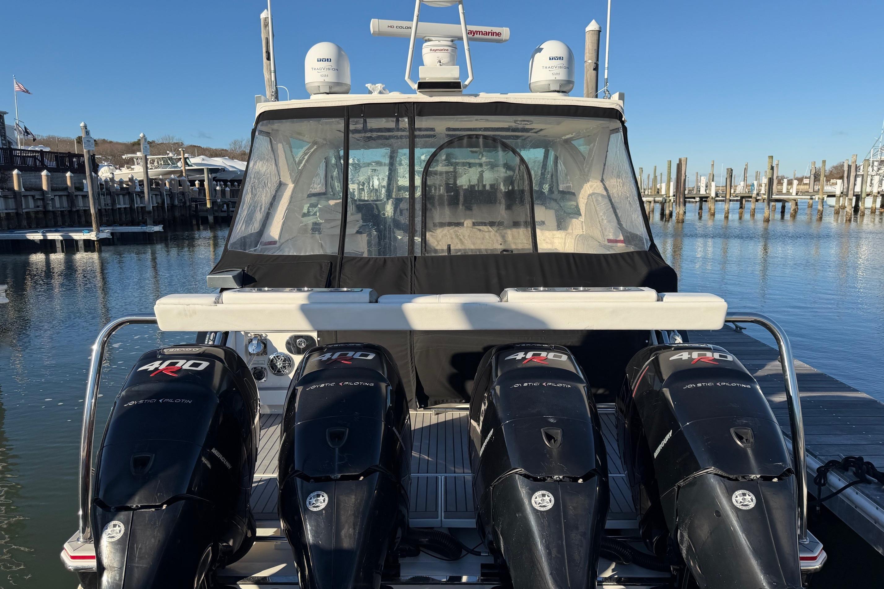 2017 Formula 430 Super Sport Crossover with four powerful outboard engines docked at marina.