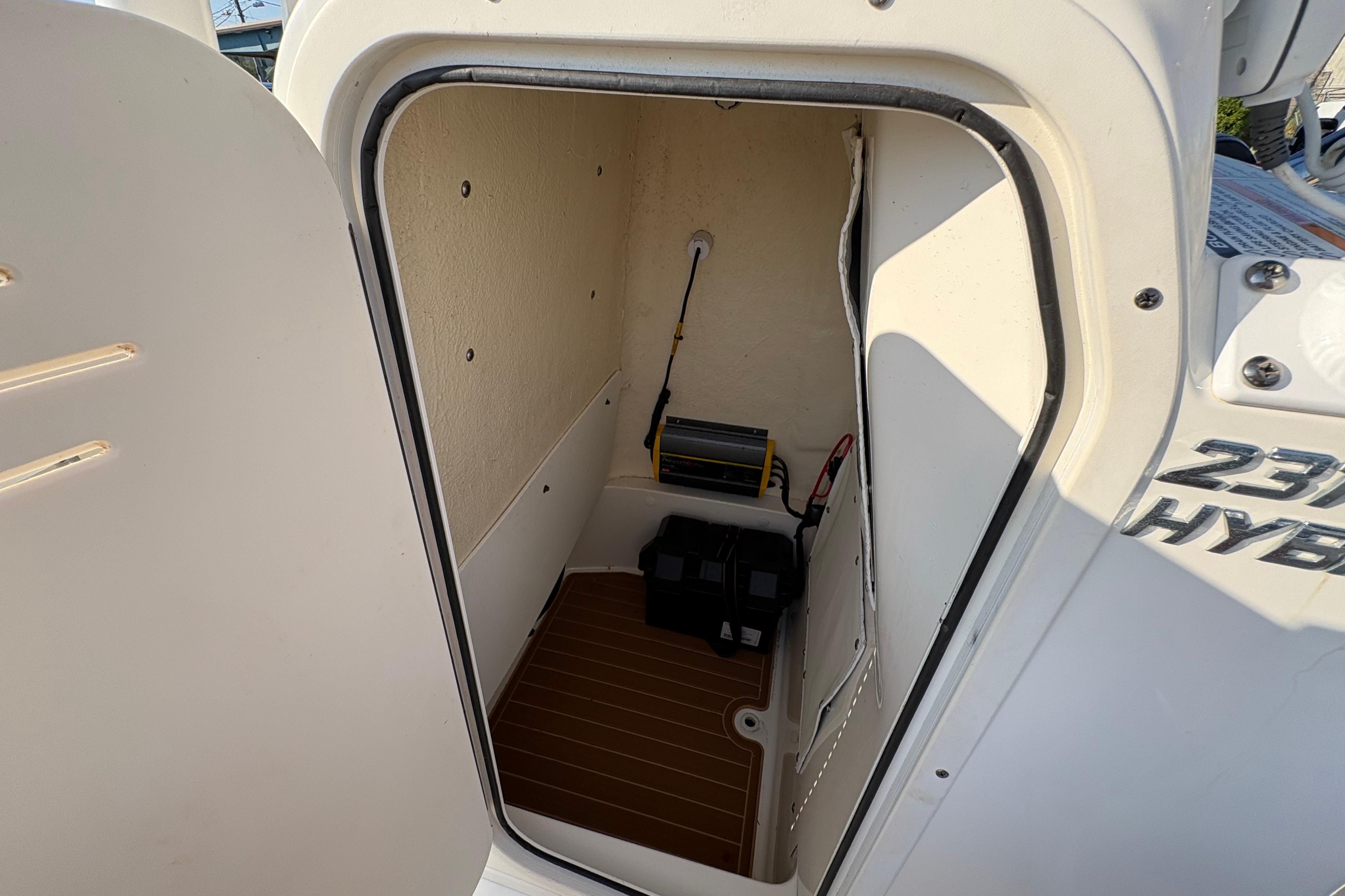 Storage compartment of a 2019 NauticStar 231 Hybrid boat, featuring interior equipment.