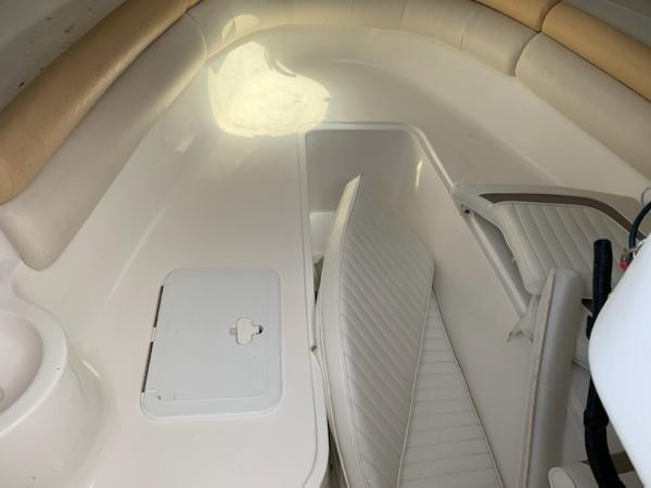 2008 Sea Fox 236WA Pro Series cabin interior with white seating and storage compartments.
