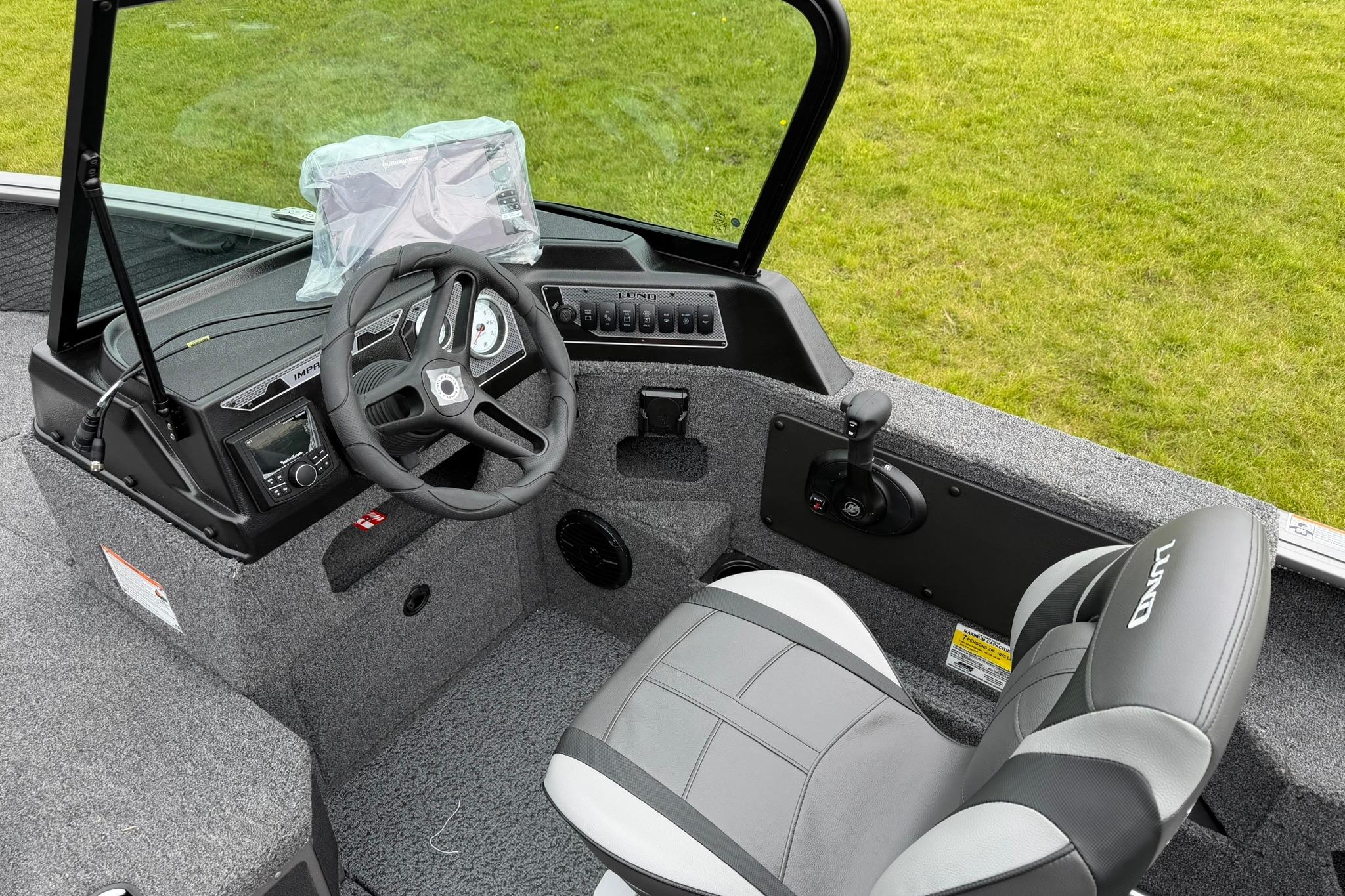 2027 Lund 1875 Impact XS Sport boat interior with steering wheel and seat.