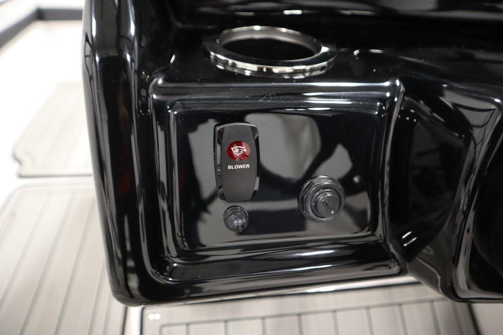 Control panel of 2026 Yamaha Boats 195S with blower switch and cup holder.