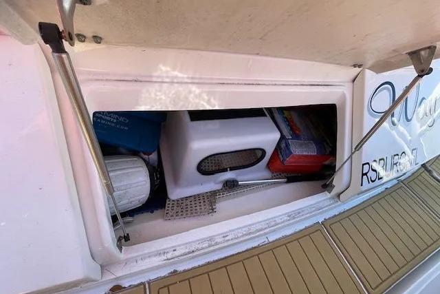 Storage compartment on a 2016 Sea Ray Sundancer 510 yacht, containing various boating supplies.