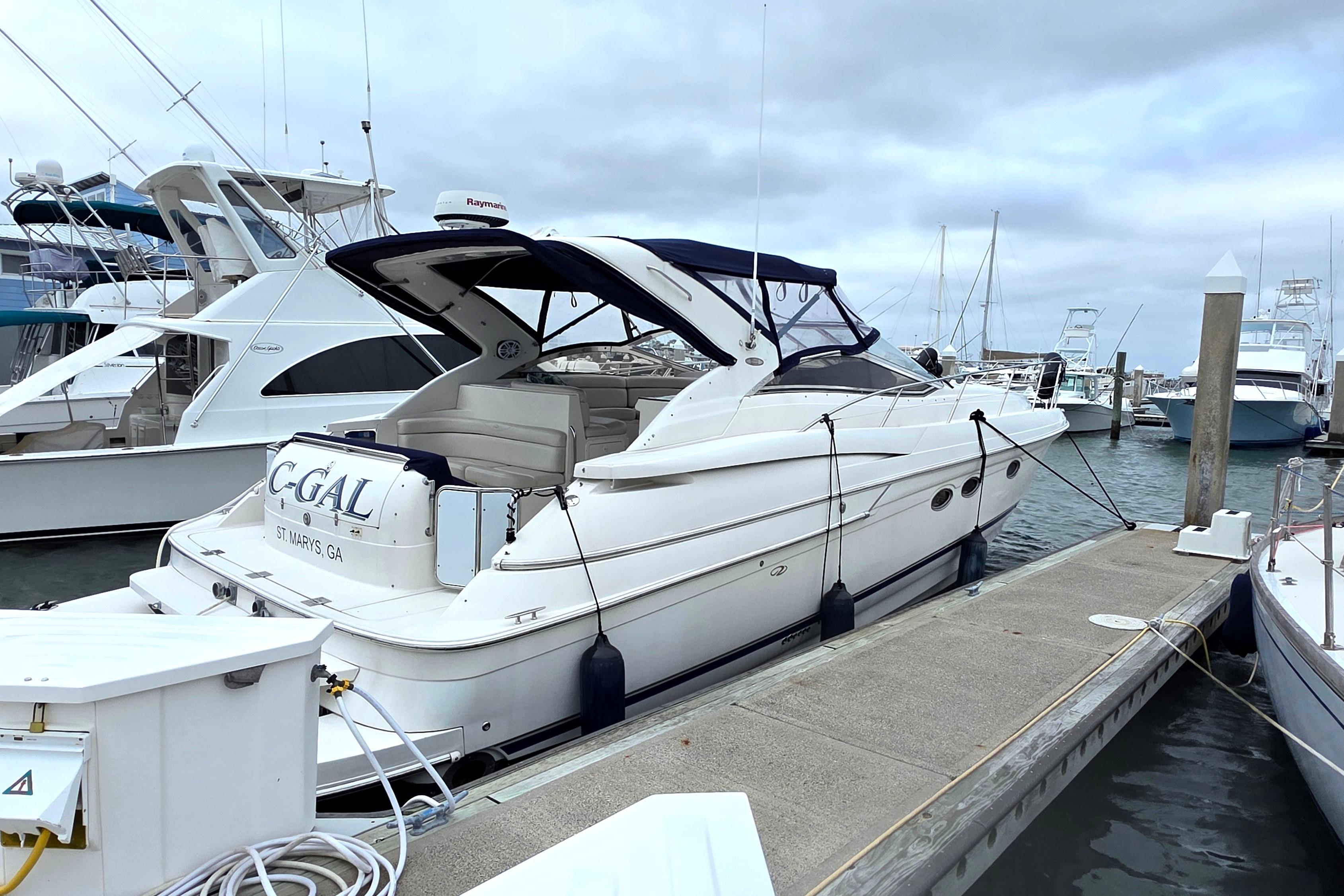 2002 Regal Commodore 4260 yacht docked at marina, overcast sky, side view.