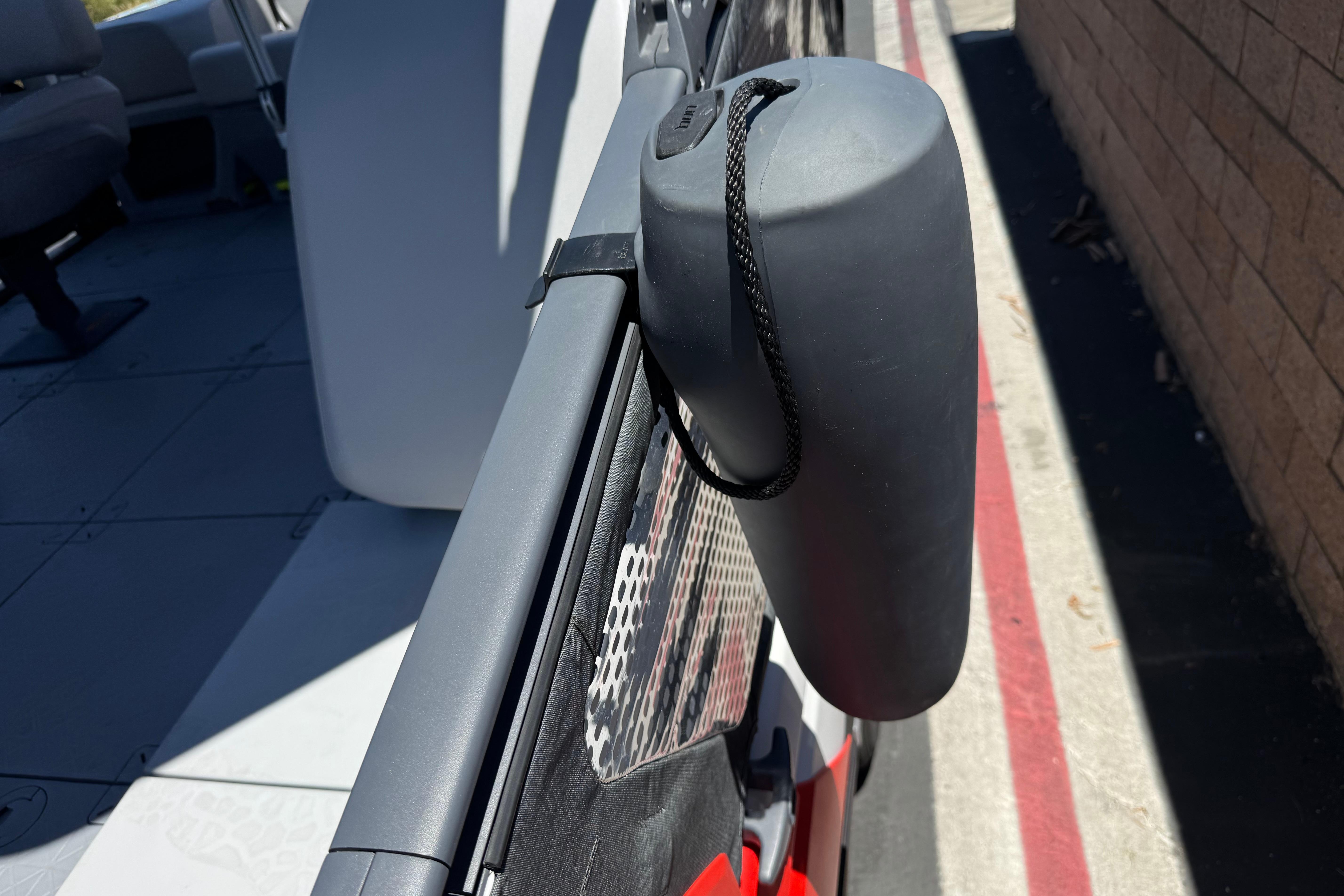 2024 Sea-Doo Switch Compact boat with attached fender for protection.