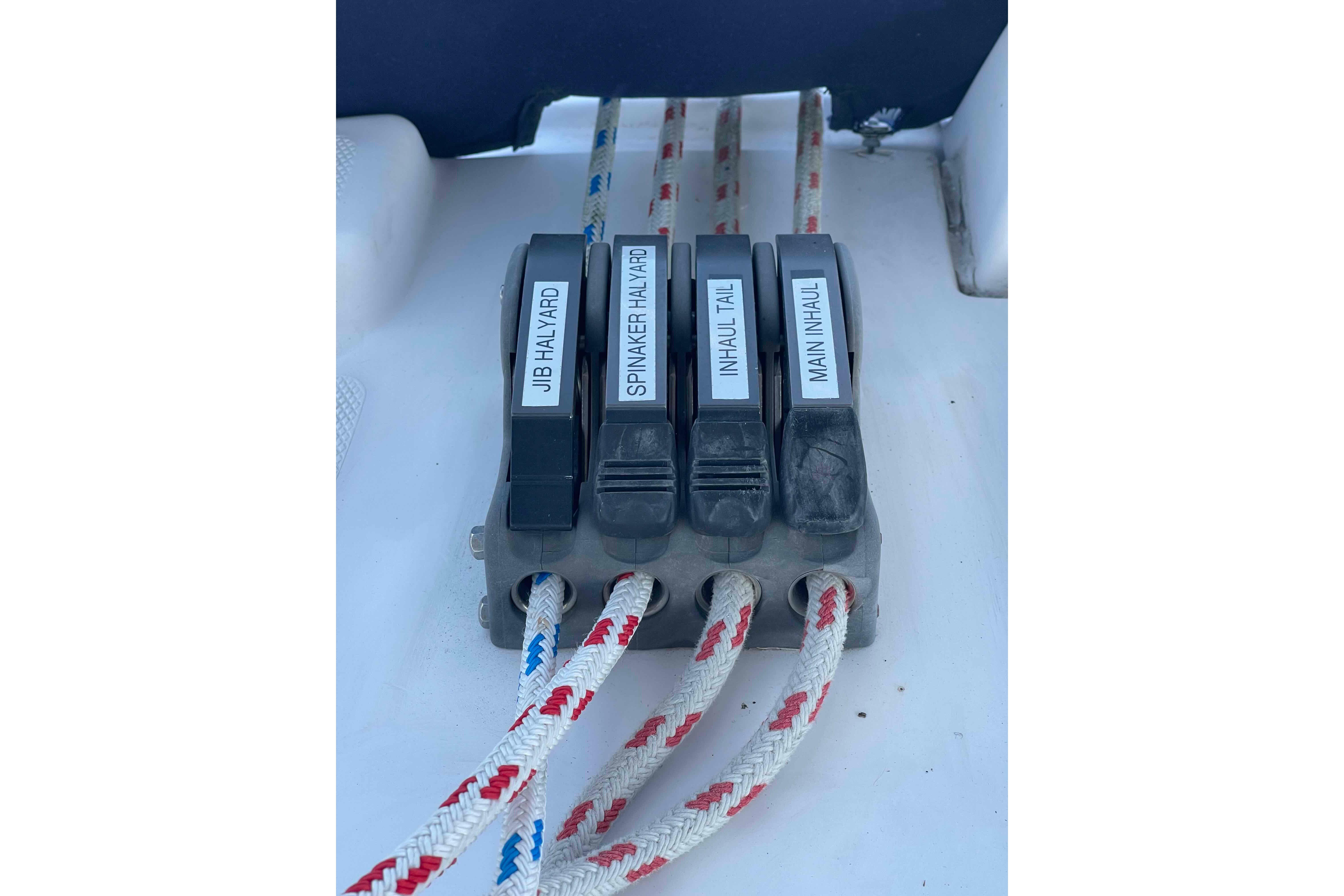 Rope clutches on 2010 Hunter 45 Center Cockpit sailboat, labeled for various halyards and inhauls.