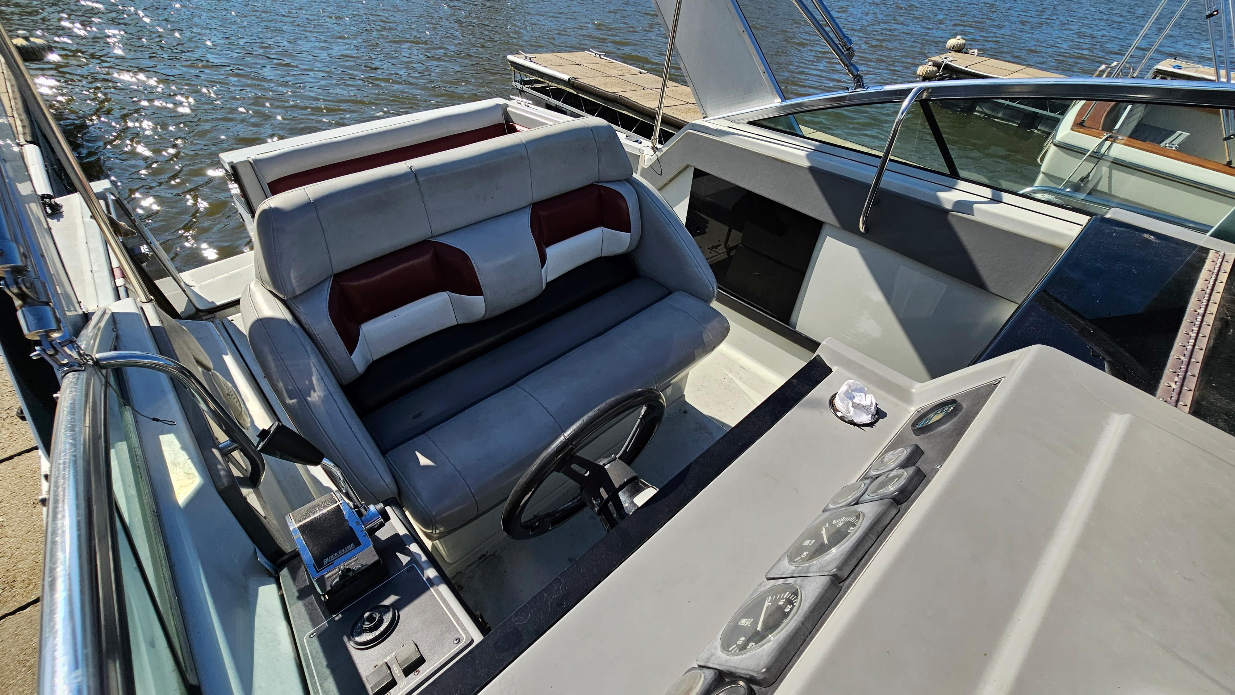 1988 Formula 26 PC boat cockpit with steering wheel and seating.