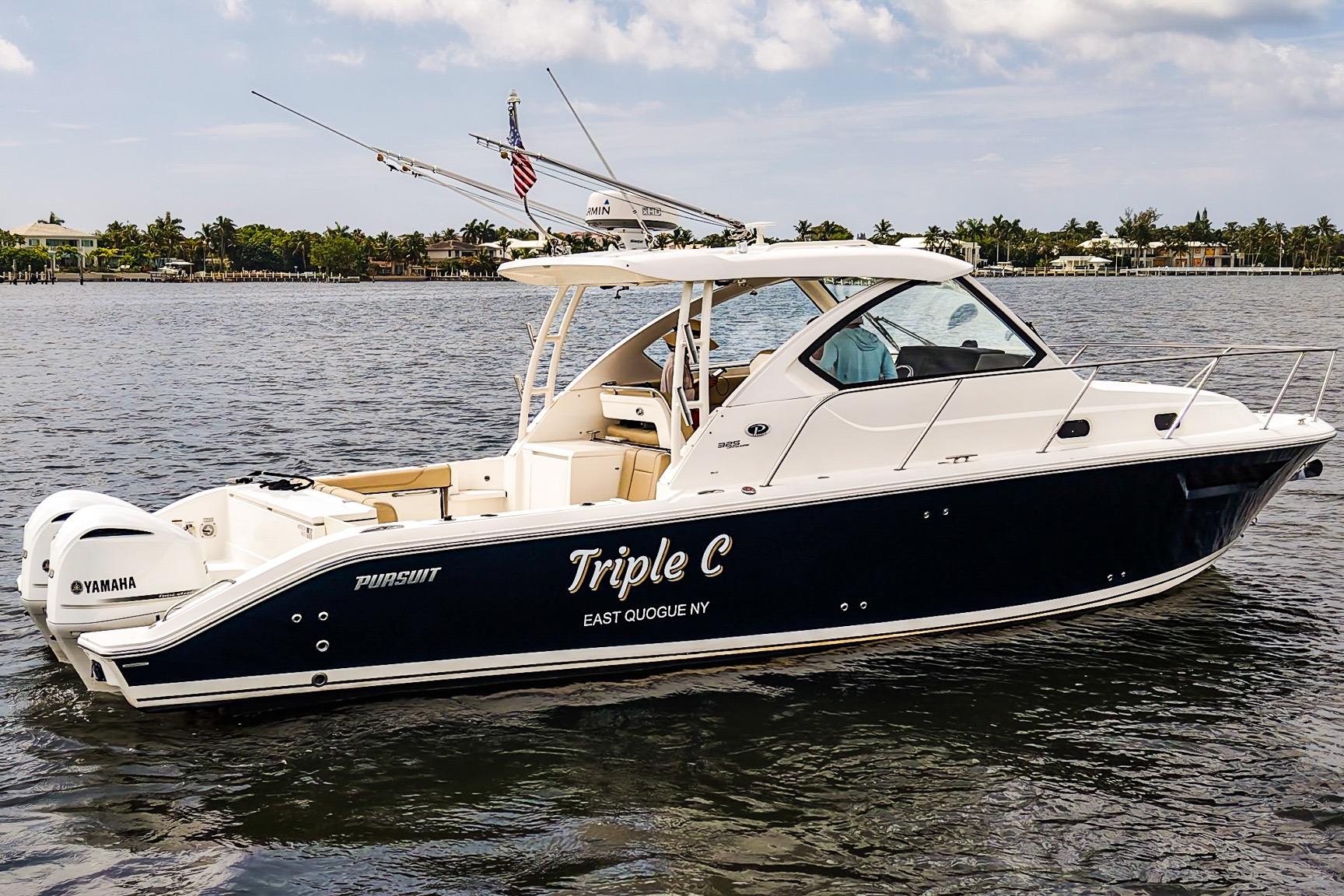 2020 Pursuit OS 325 Offshore boat on water, featuring Yamaha engines and sleek design.