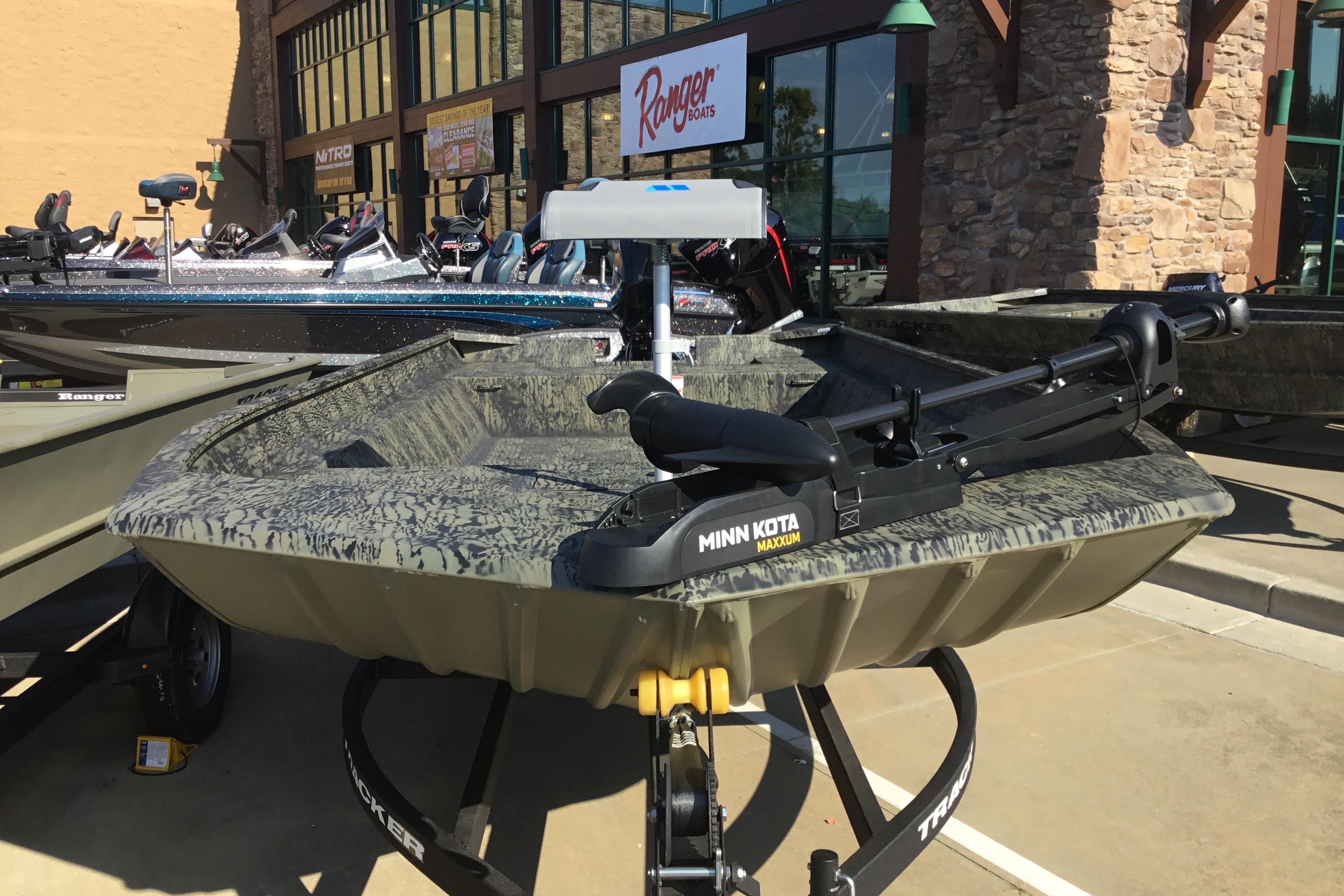 2025 Tracker Grizzly 2072 Utility boat with Minn Kota Maxxum motor displayed outdoors.