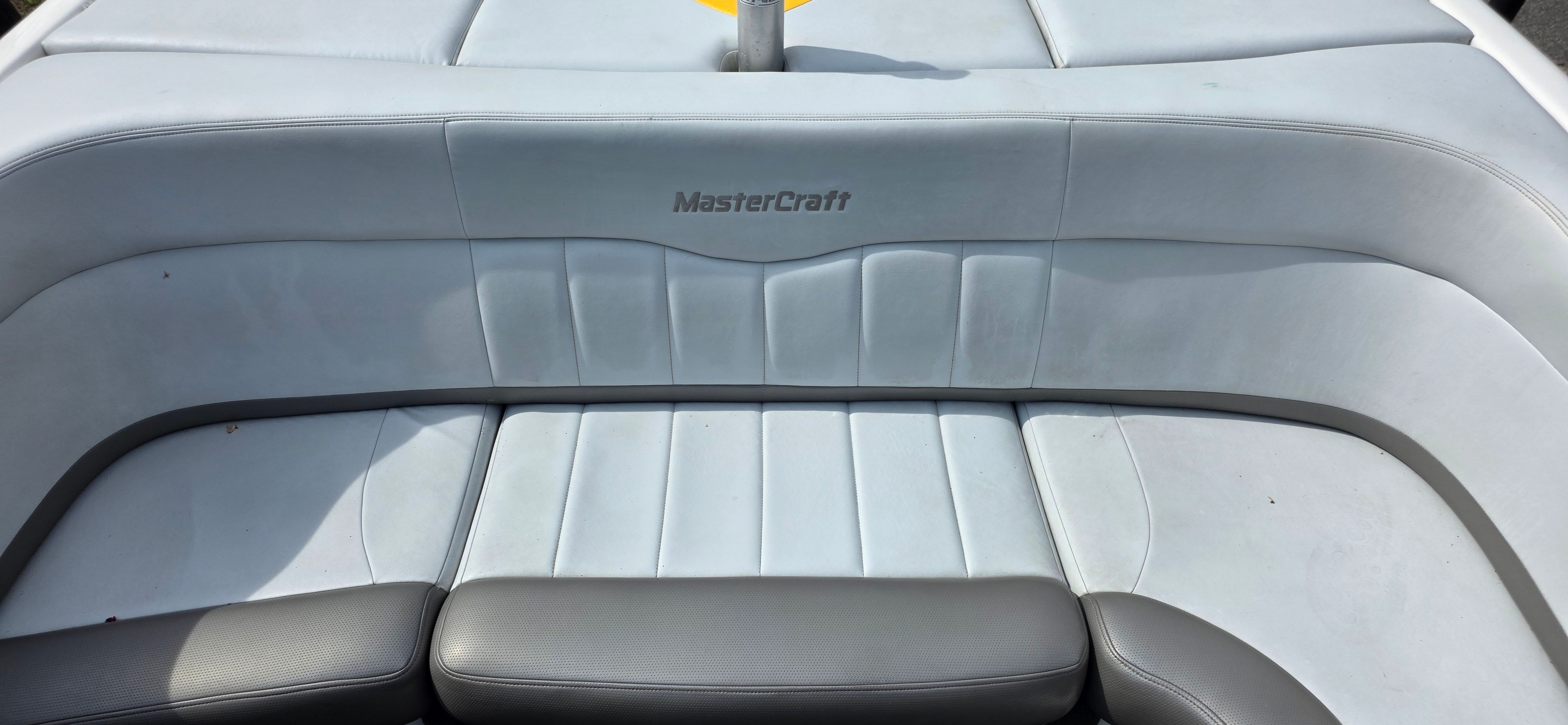 Interior of a 2004 MasterCraft Maristar boat with gray upholstery.