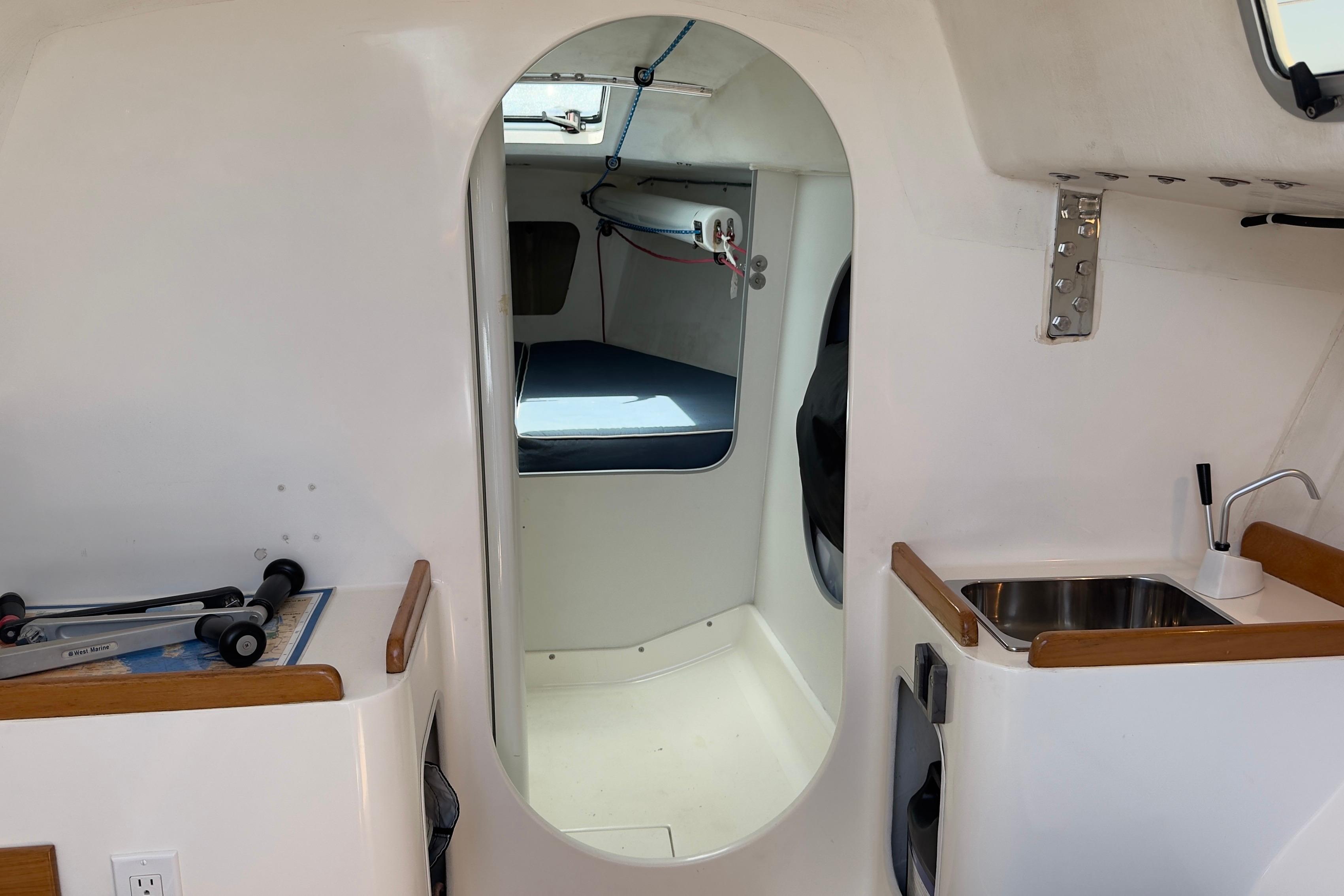 Interior of a 1994 J Boats J/92 sailboat, featuring a compact cabin and sink area.