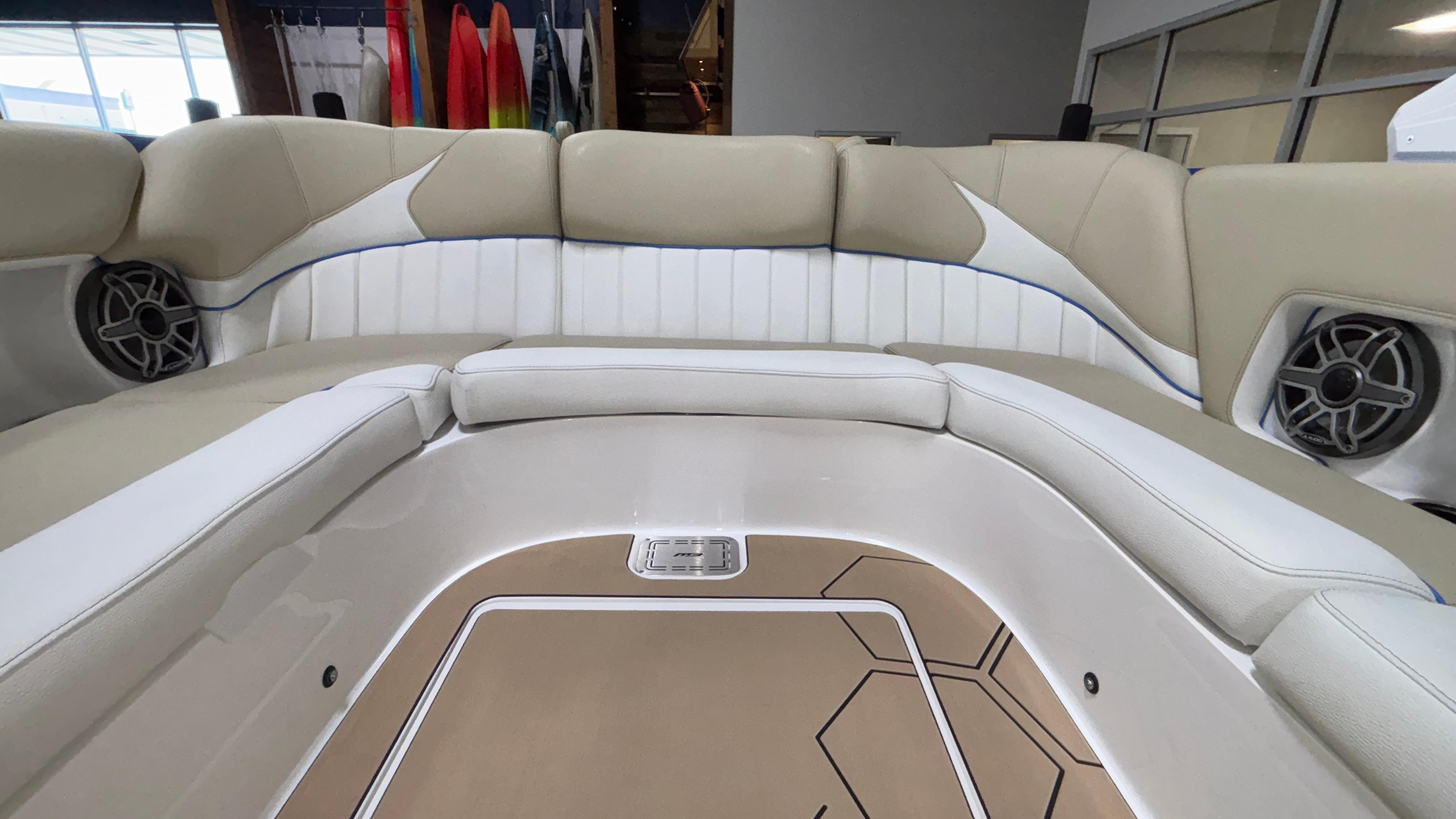Luxurious interior of 2025 MB B52 23 Classic boat with beige and white seating.