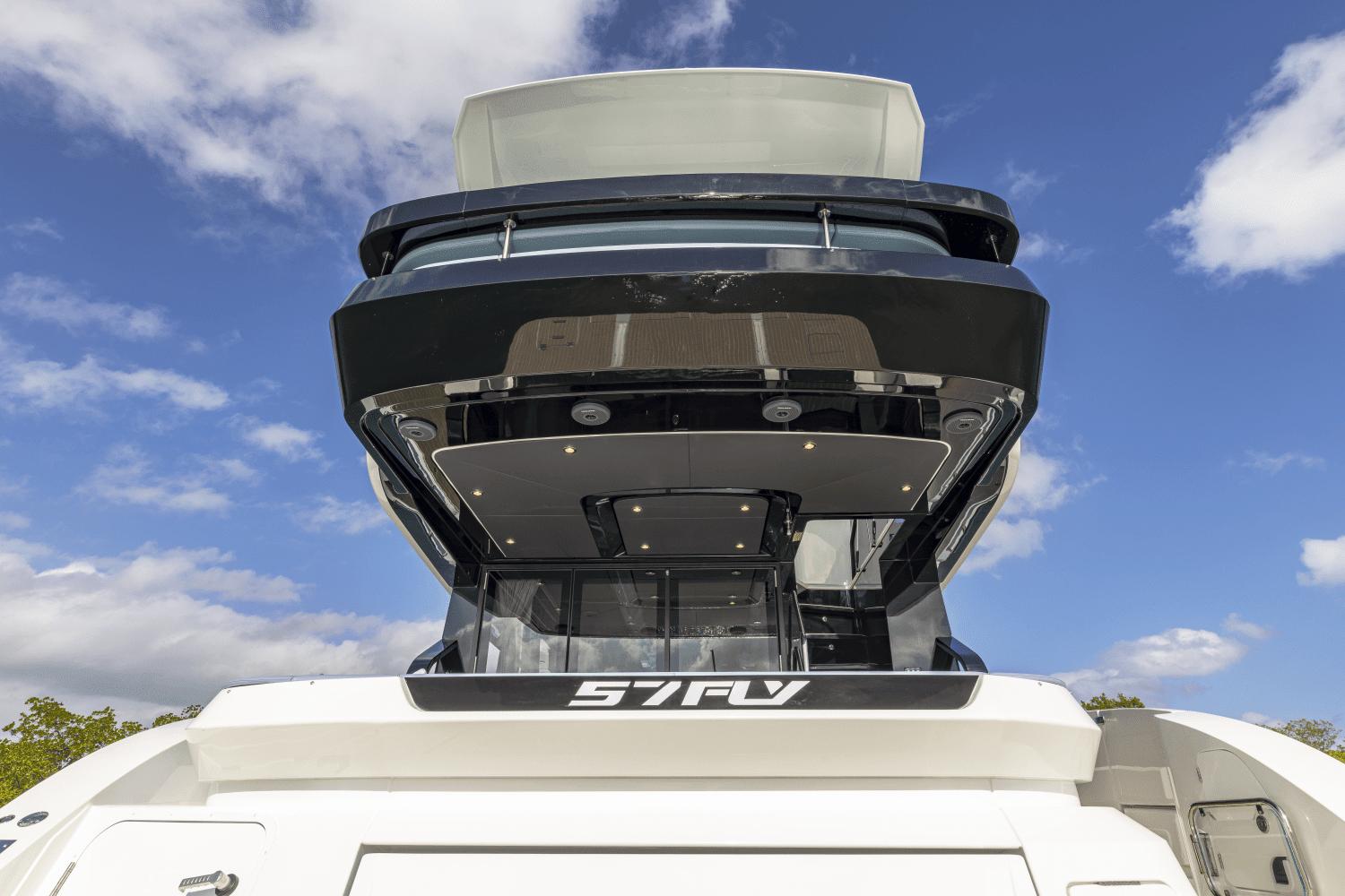 2025 Cruisers Yachts 57 Fly, rear view against blue sky.