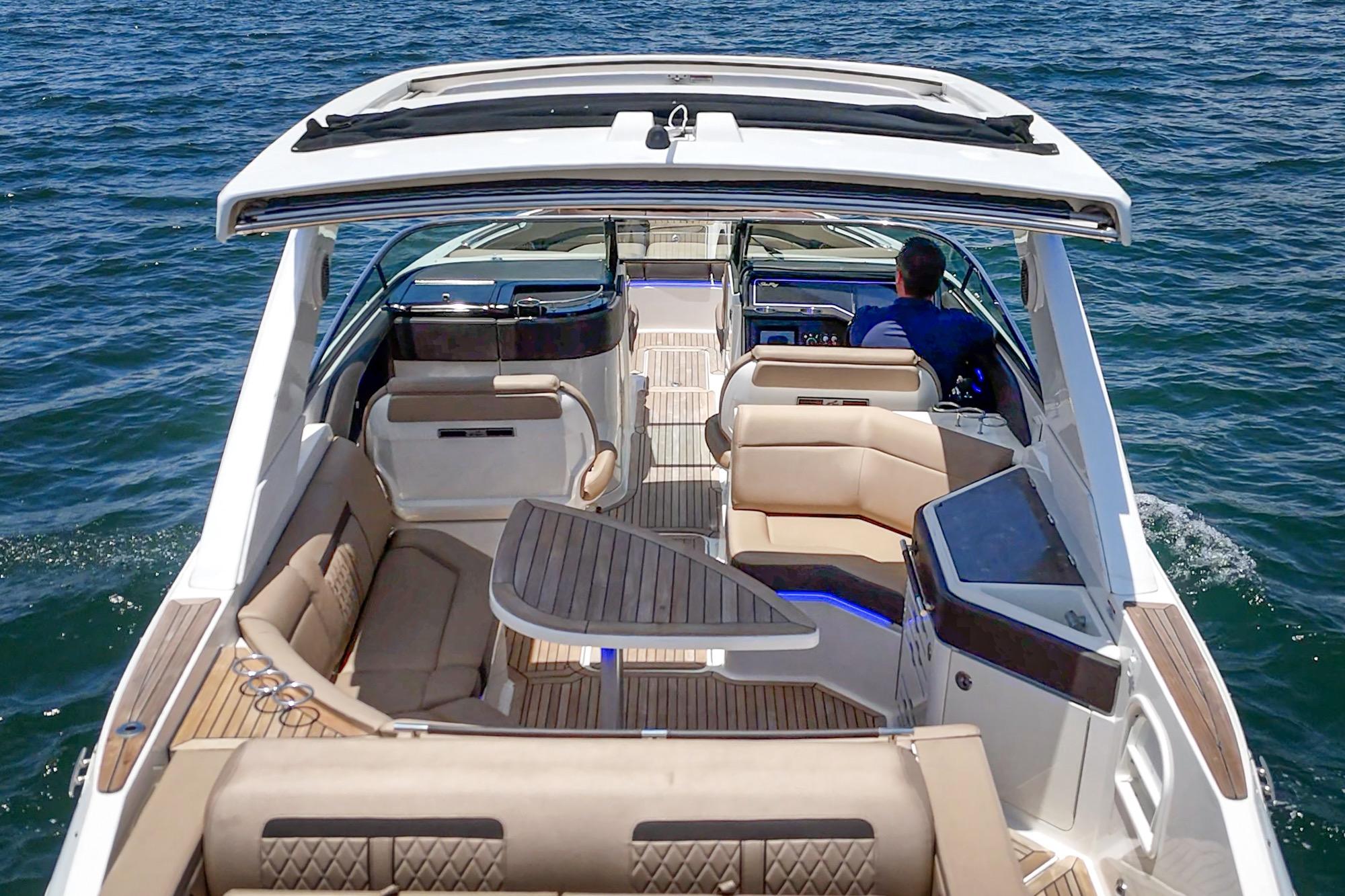 2018 Sea Ray SLX 310 boat cruising on open water, featuring luxurious seating and modern design.