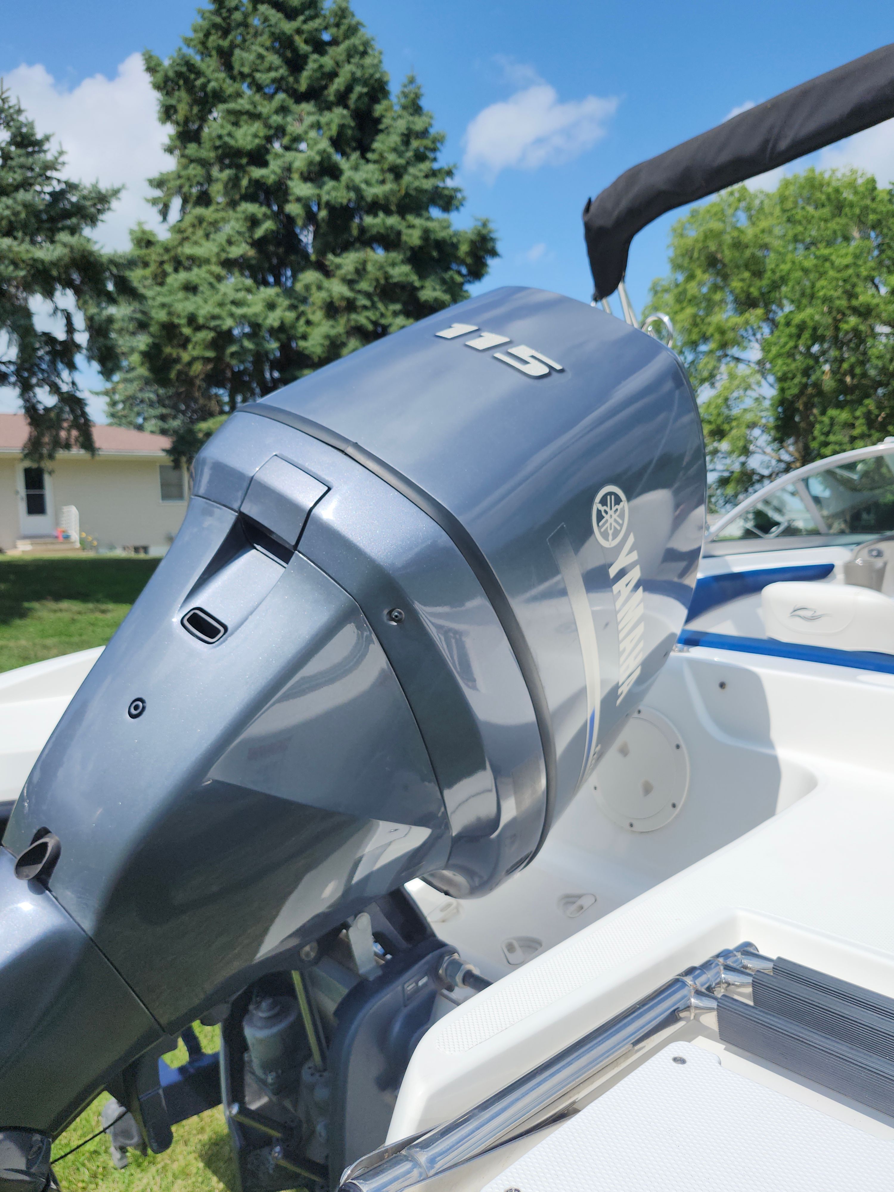 A 2013 Rinker 186 Captiva fish/ski with a Yamaha 115 outboard motor, parked outdoors.