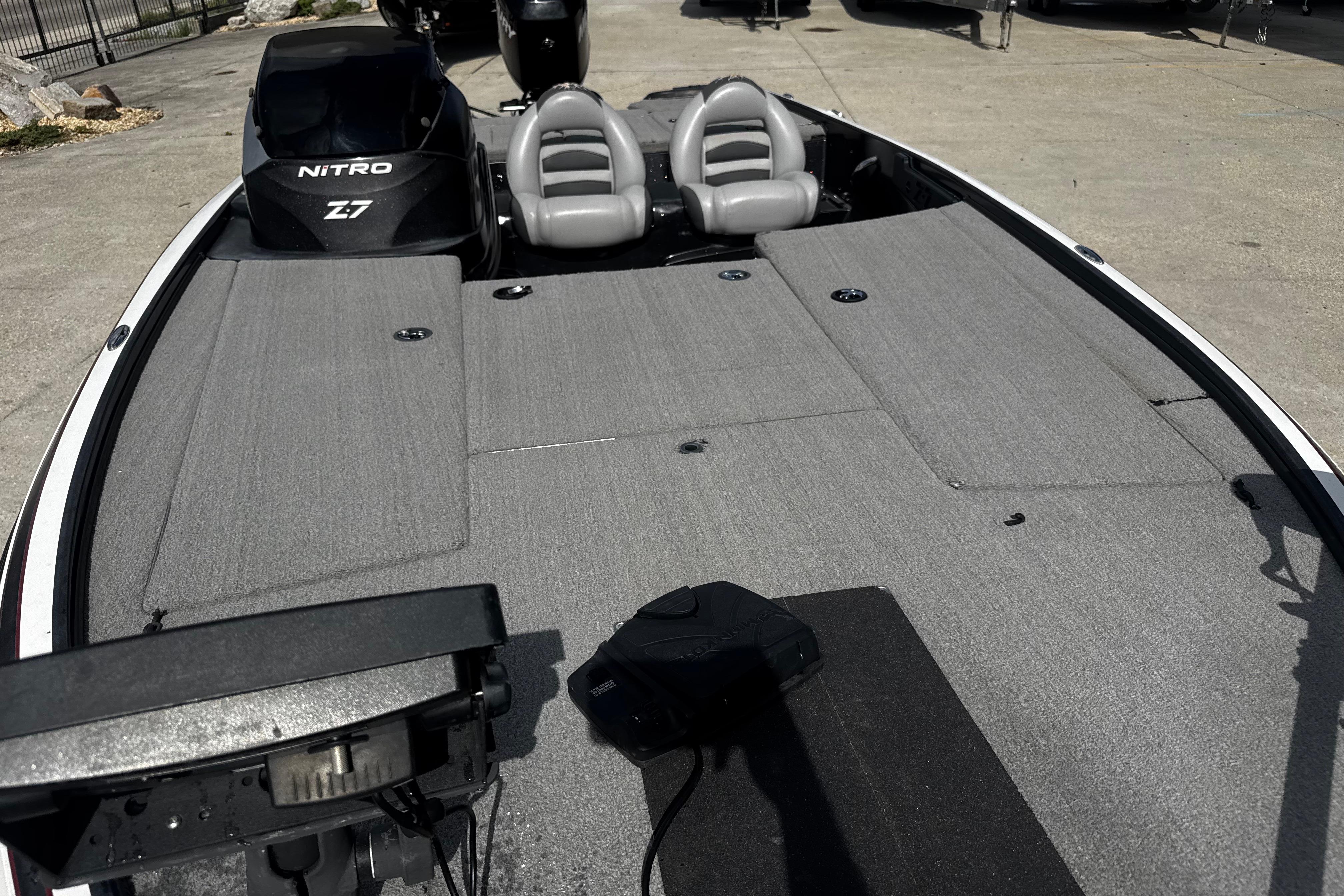 2012 Nitro Z-7 boat with gray deck and dual seats, parked outdoors.