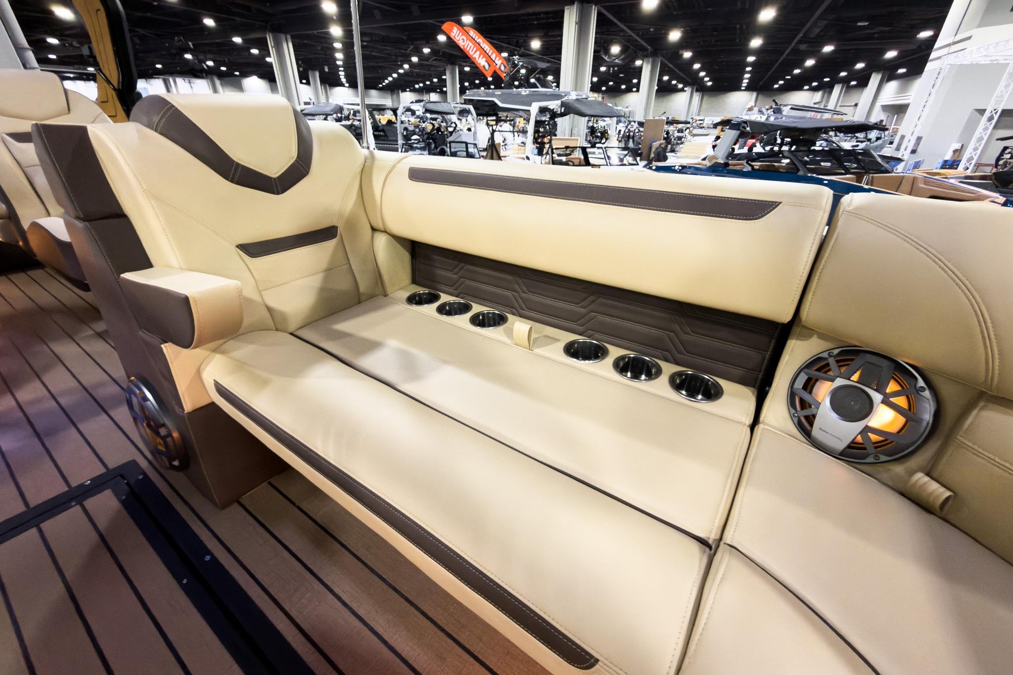 Luxurious seating in 2026 Montara Surf Boss EVO boat, featuring cup holders and speaker system.