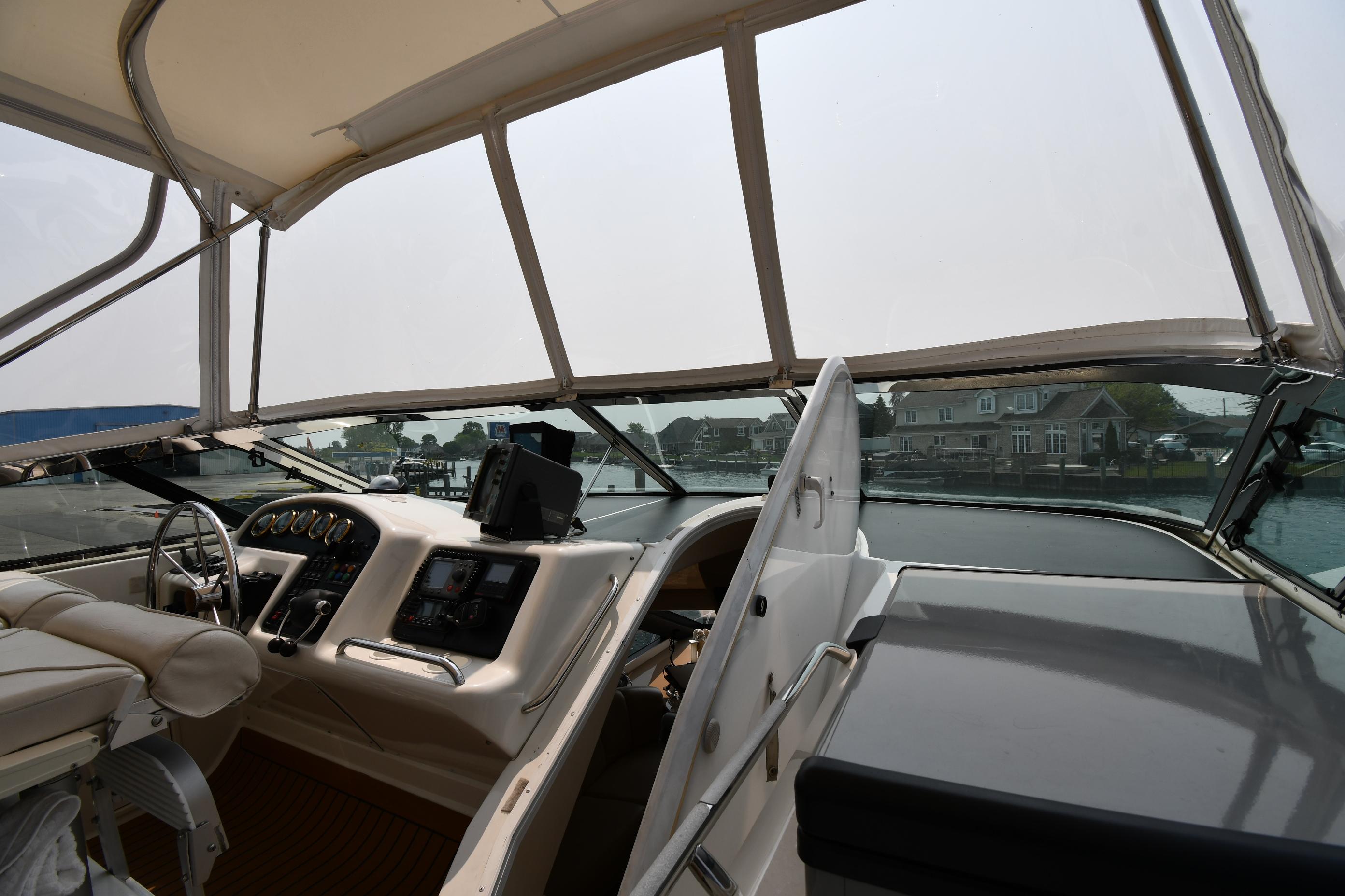 Interior view of 1998 Carver 530 Voyager Pilothouse yacht cockpit with steering and navigation controls.