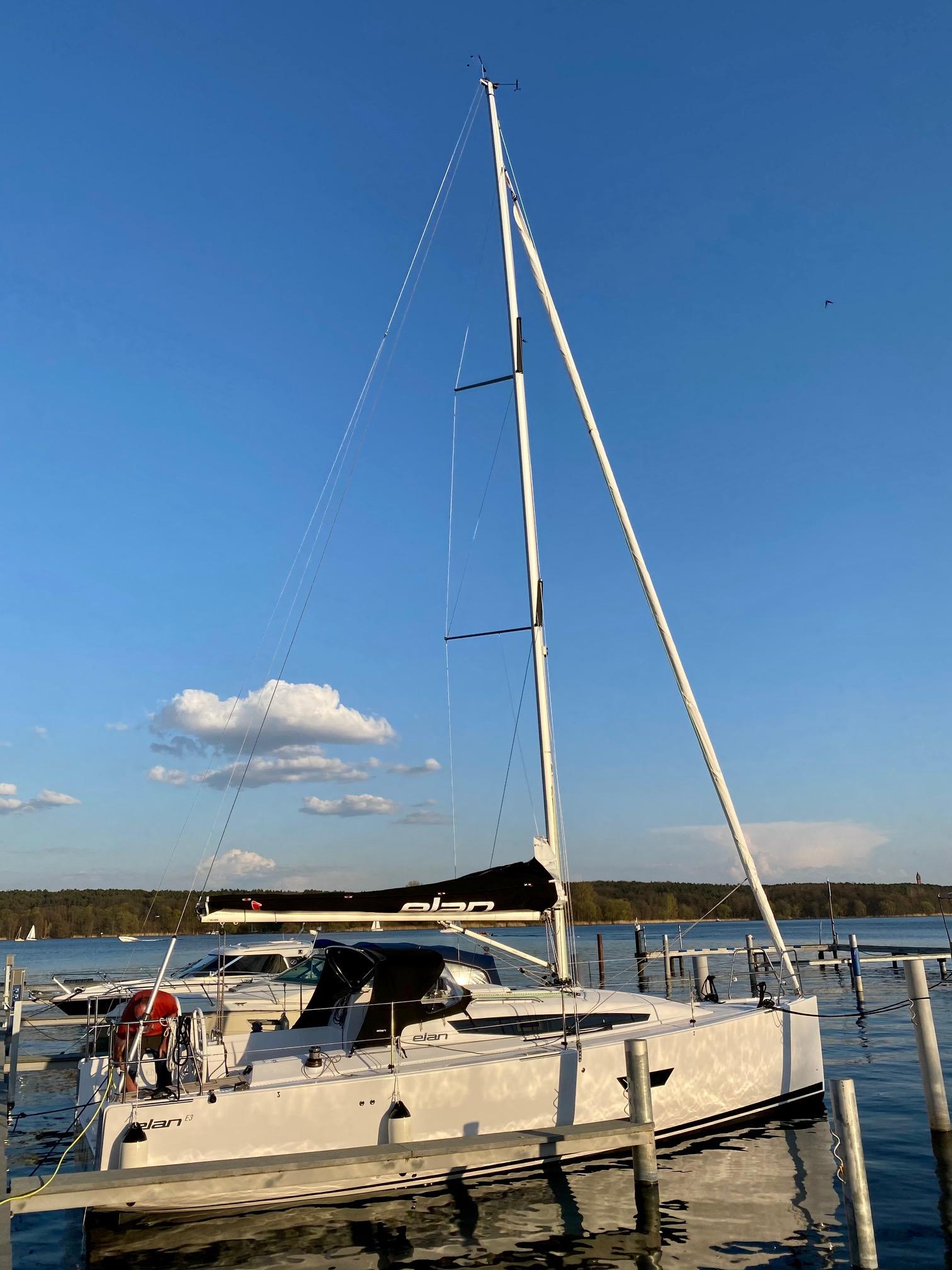 2020 Elan E3 sailboat docked on a sunny day with clear blue skies.