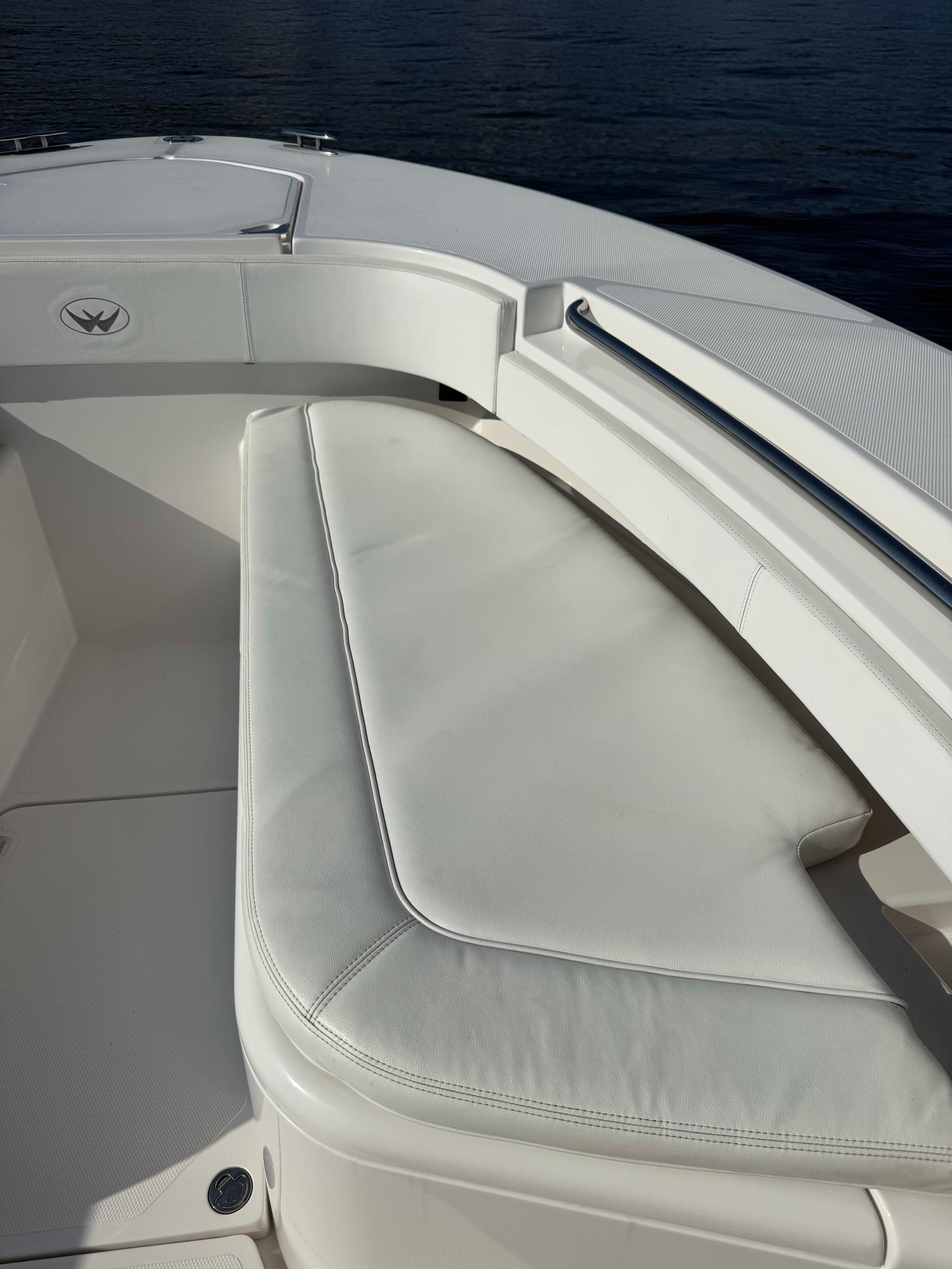 2017 Southport 272 FE boat with white cushioned seating, docked on calm water.