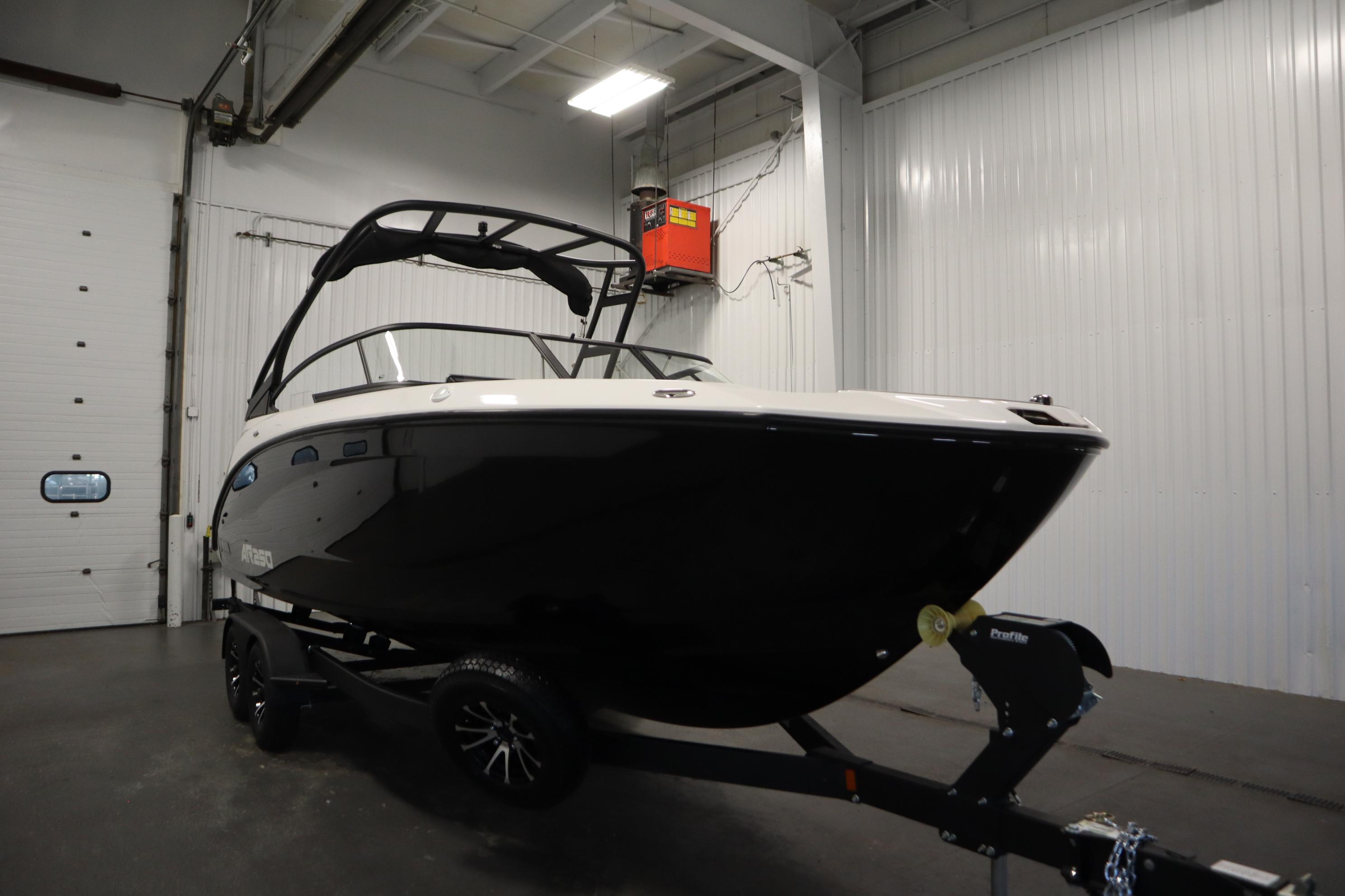 2026 Yamaha AR250 boat in a garage, black hull, on a trailer.