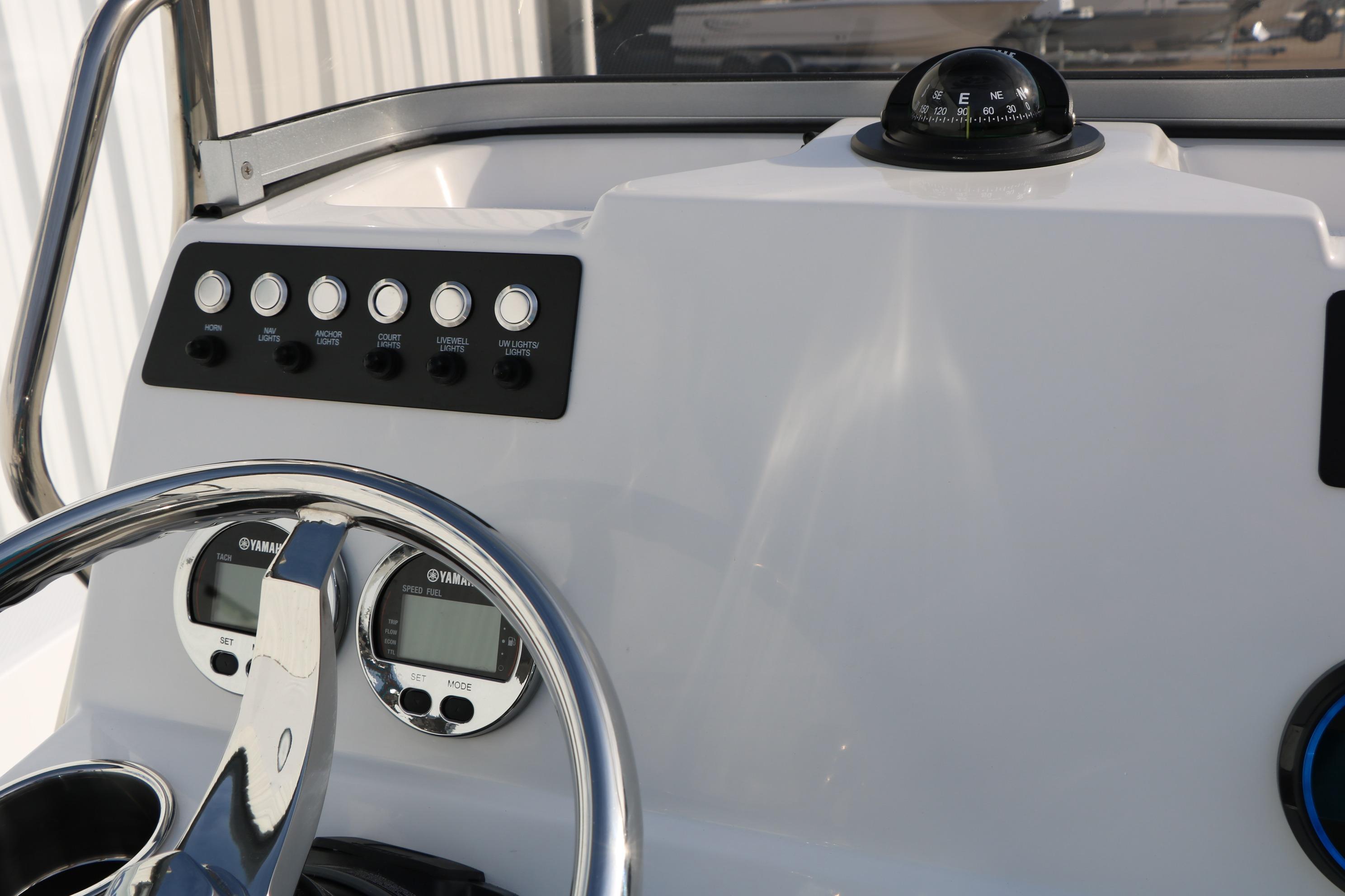 Dashboard of 2026 Robalo 206 Cayman boat with compass and controls.