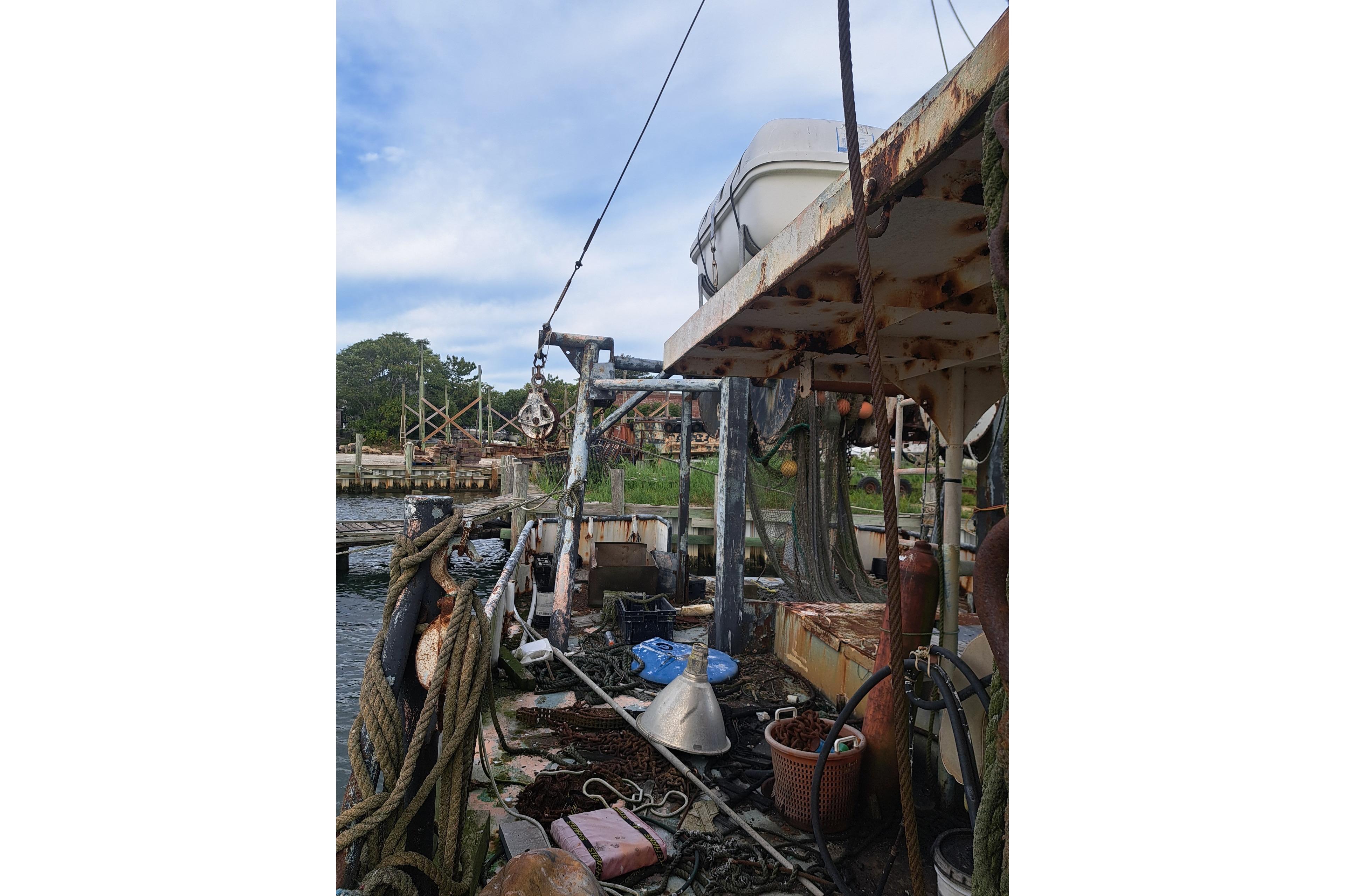 Rustic 1979 Custom Steel Trawler Dragger with fishing equipment and ropes on deck.