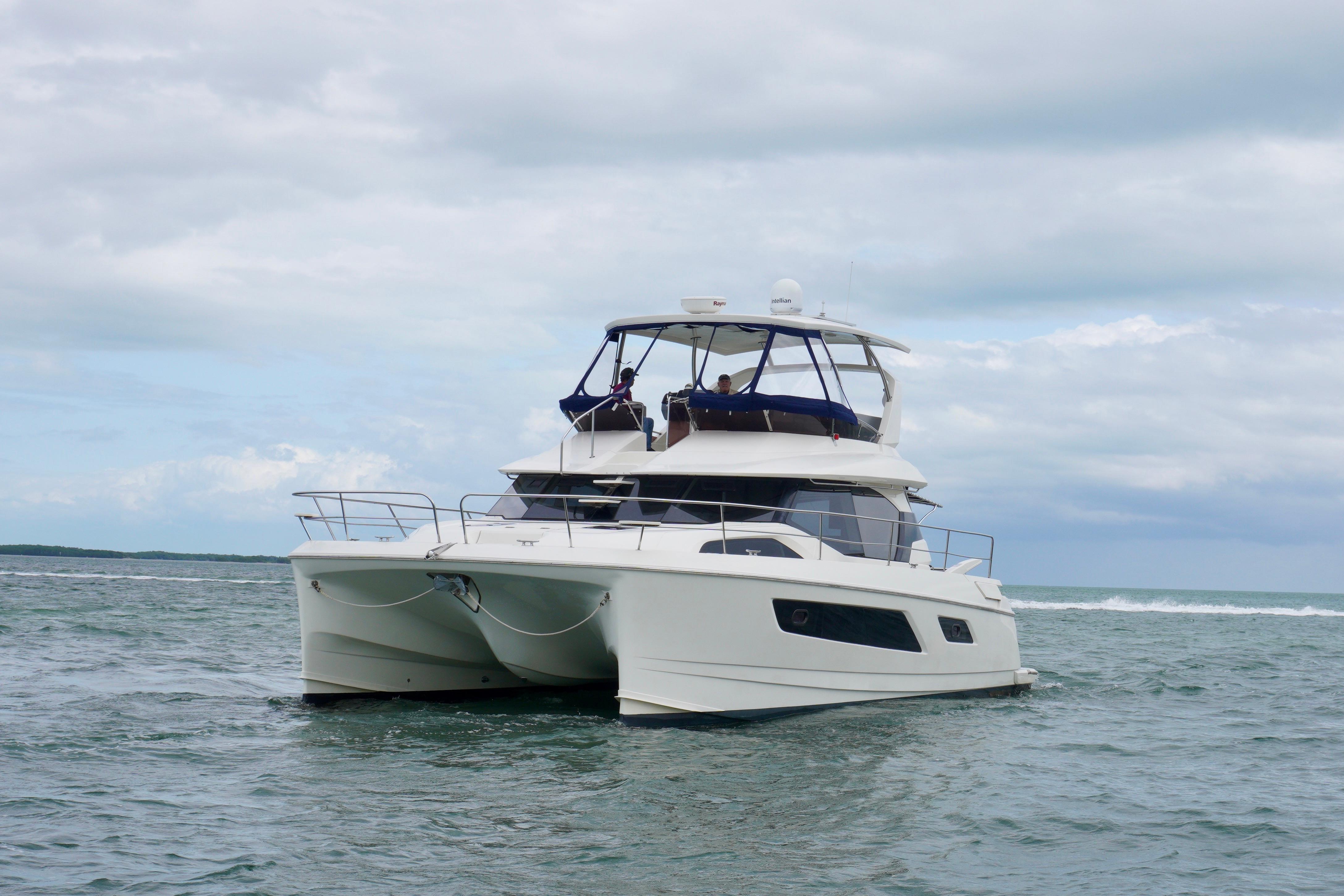 2017 Aquila 44 Yacht cruising on open water under cloudy skies.