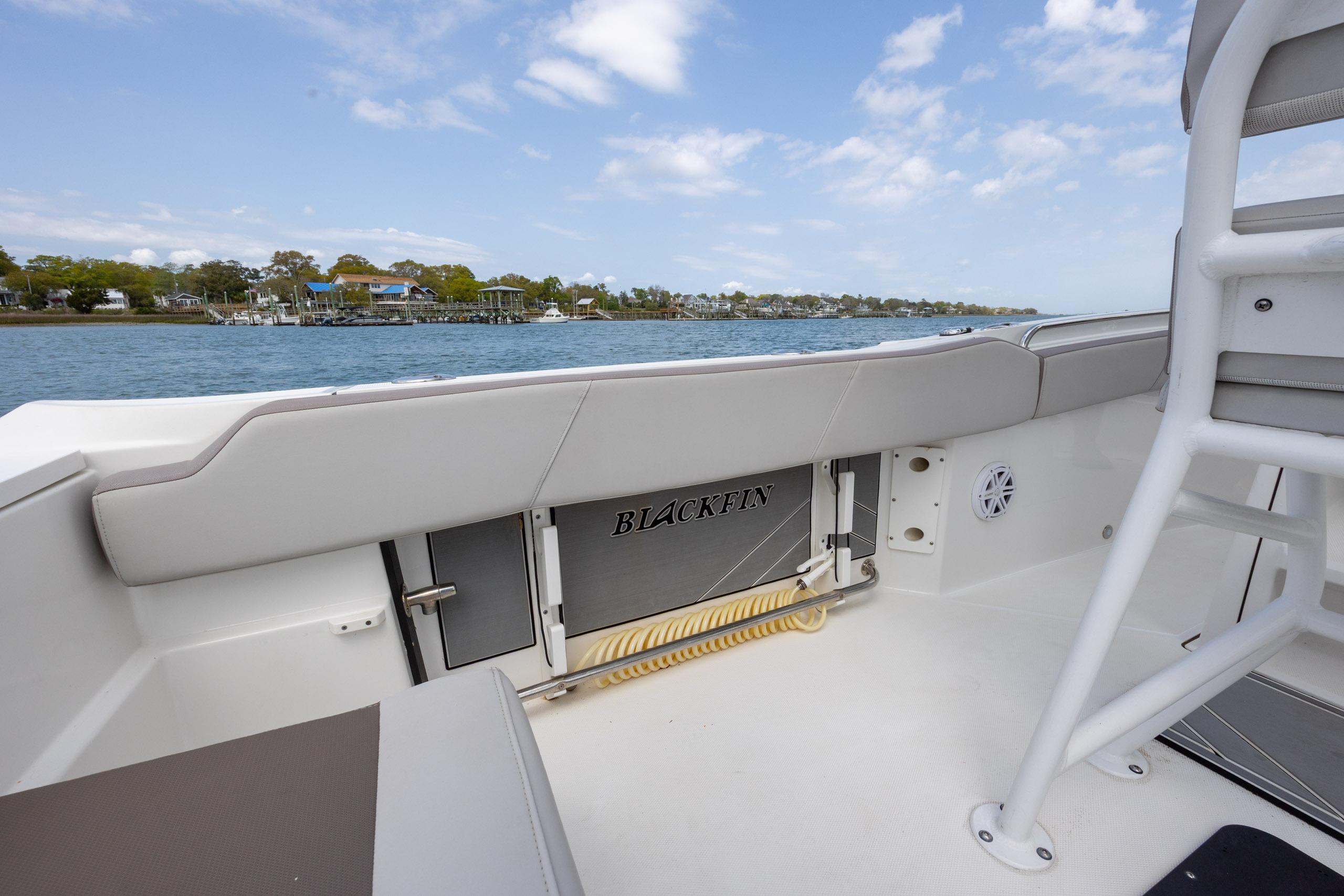 2019 Blackfin 212 CC boat interior with coastal view and clear sky.