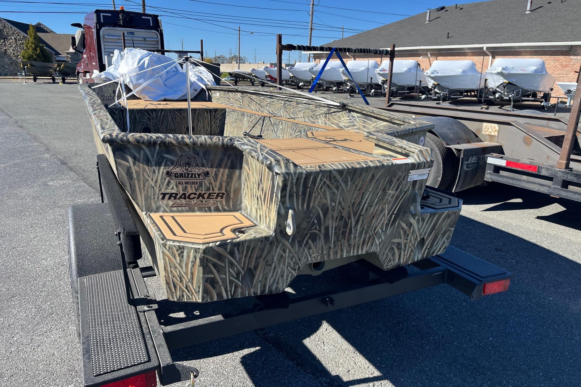 2026 Tracker Grizzly 1650 T Prairie Wings Edition boat on trailer, camo design.
