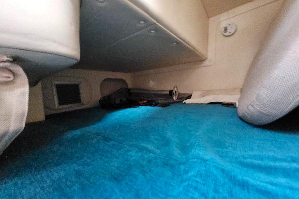 2004 Rinker Fiesta Vee 250 cabin interior with blue carpet and seating.