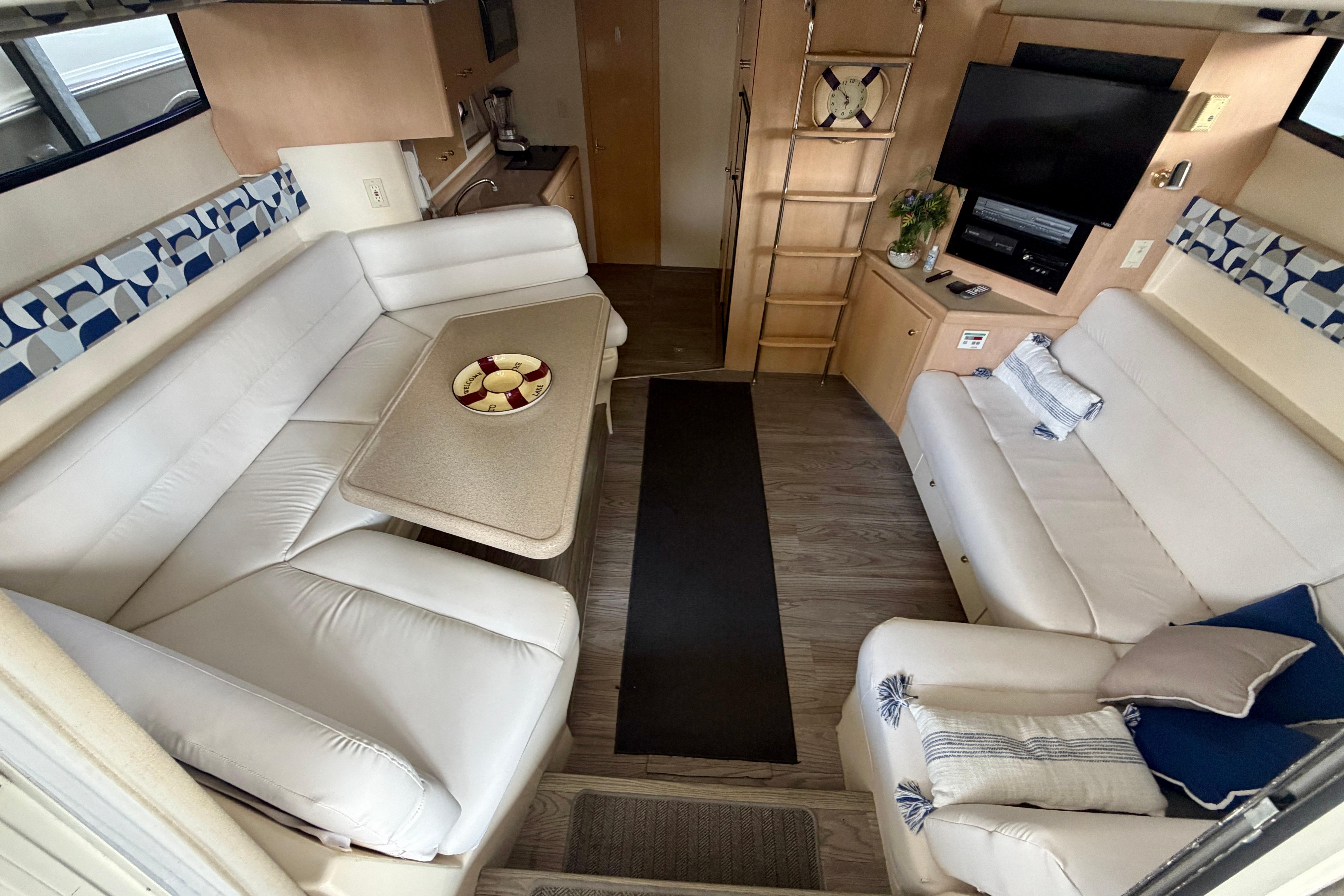 Interior of 2000 Carver 350 Mariner yacht with white seating and modern amenities.