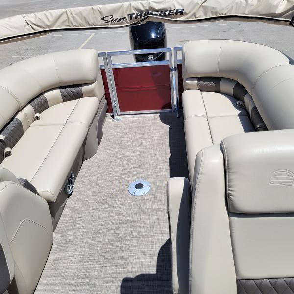 2024 Sun Tracker Party Barge 24 DLX interior with beige seating and spacious layout.