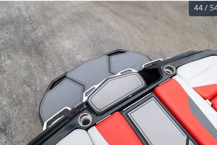 2019 MasterCraft XStar boat interior with red and gray seating and cup holders.