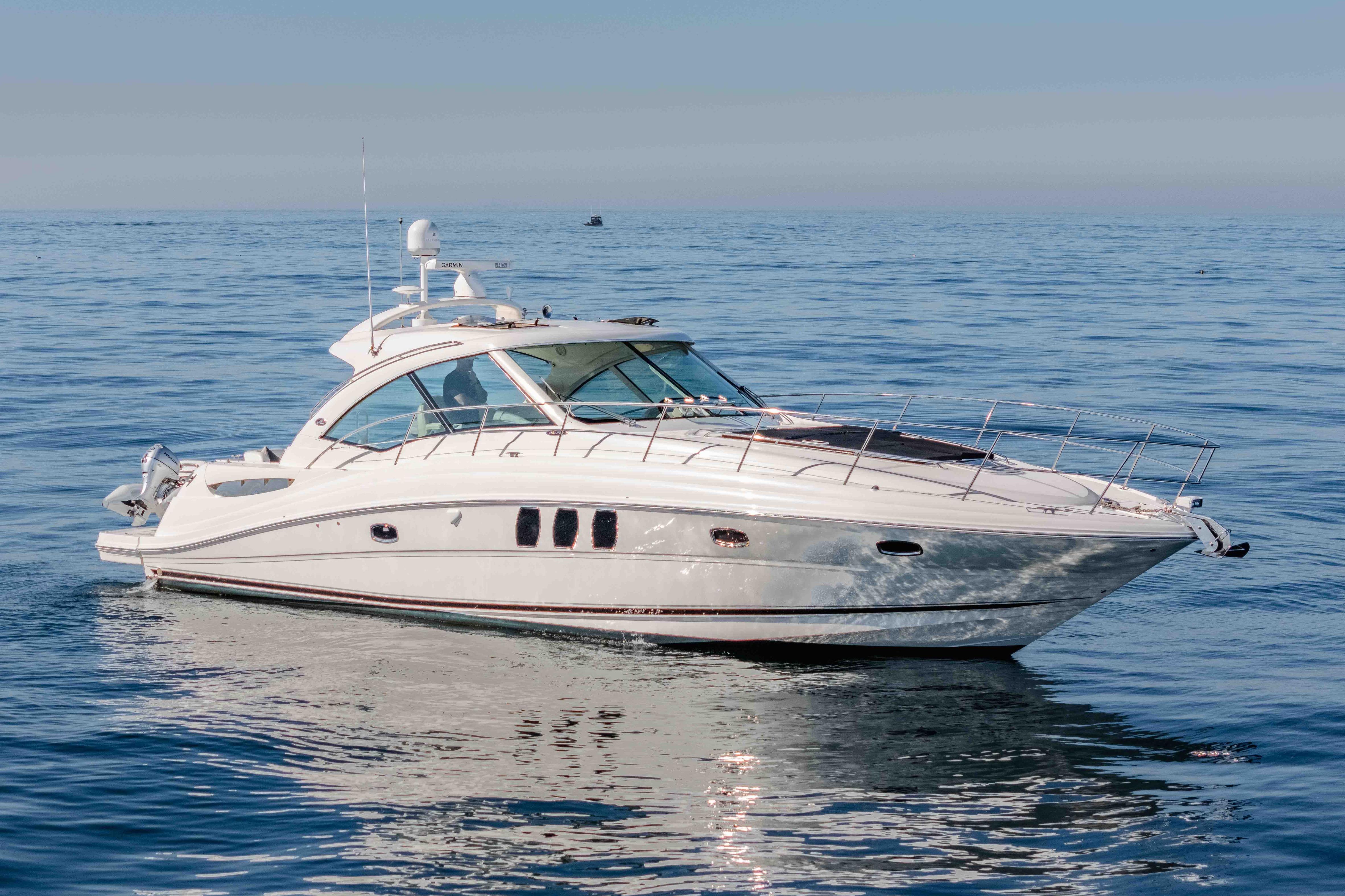 2007 Sea Ray 48 Sundancer yacht cruising on calm blue waters.