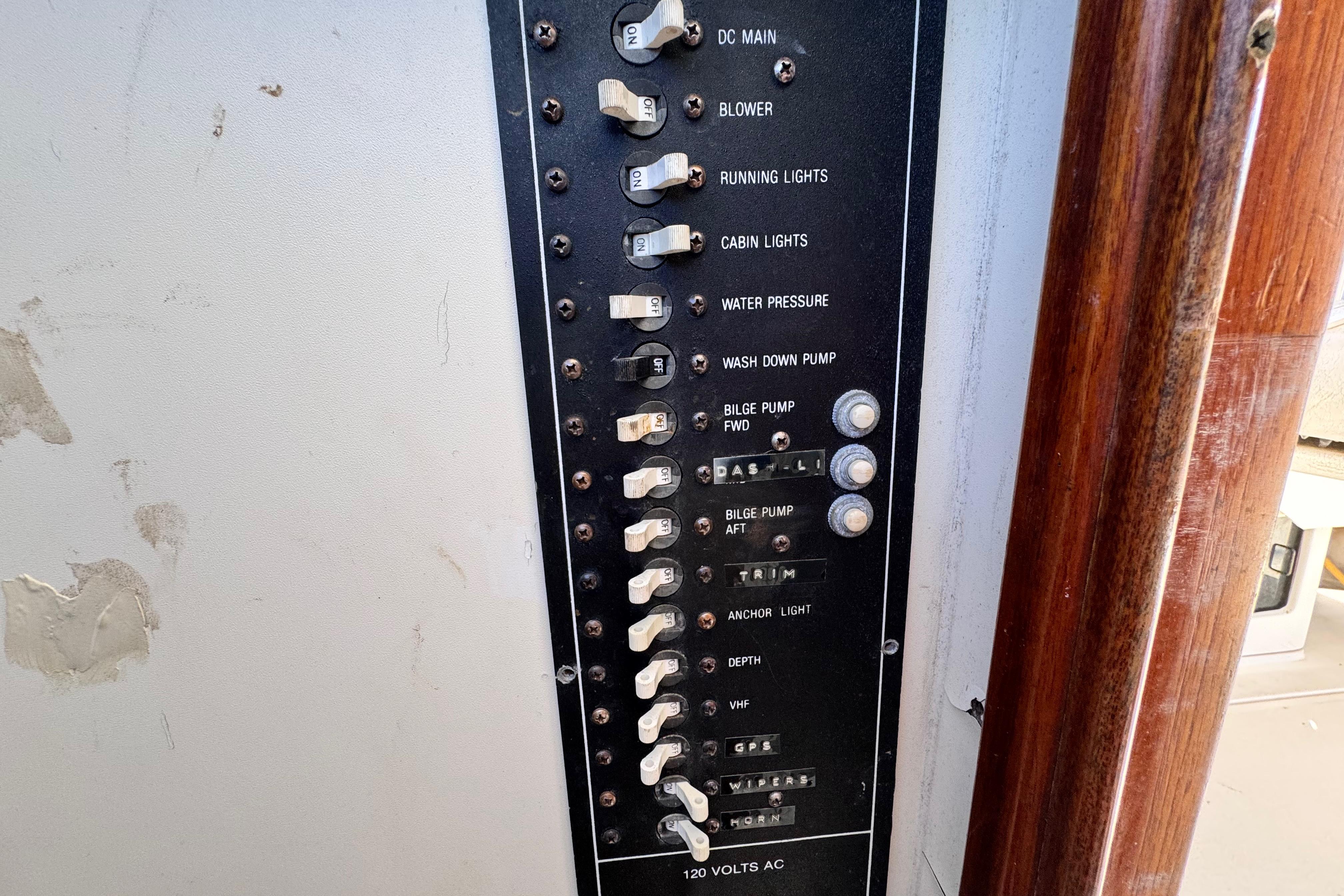 Electrical panel of a 1987 Luhrs Alura 30 boat with labeled switches and controls.