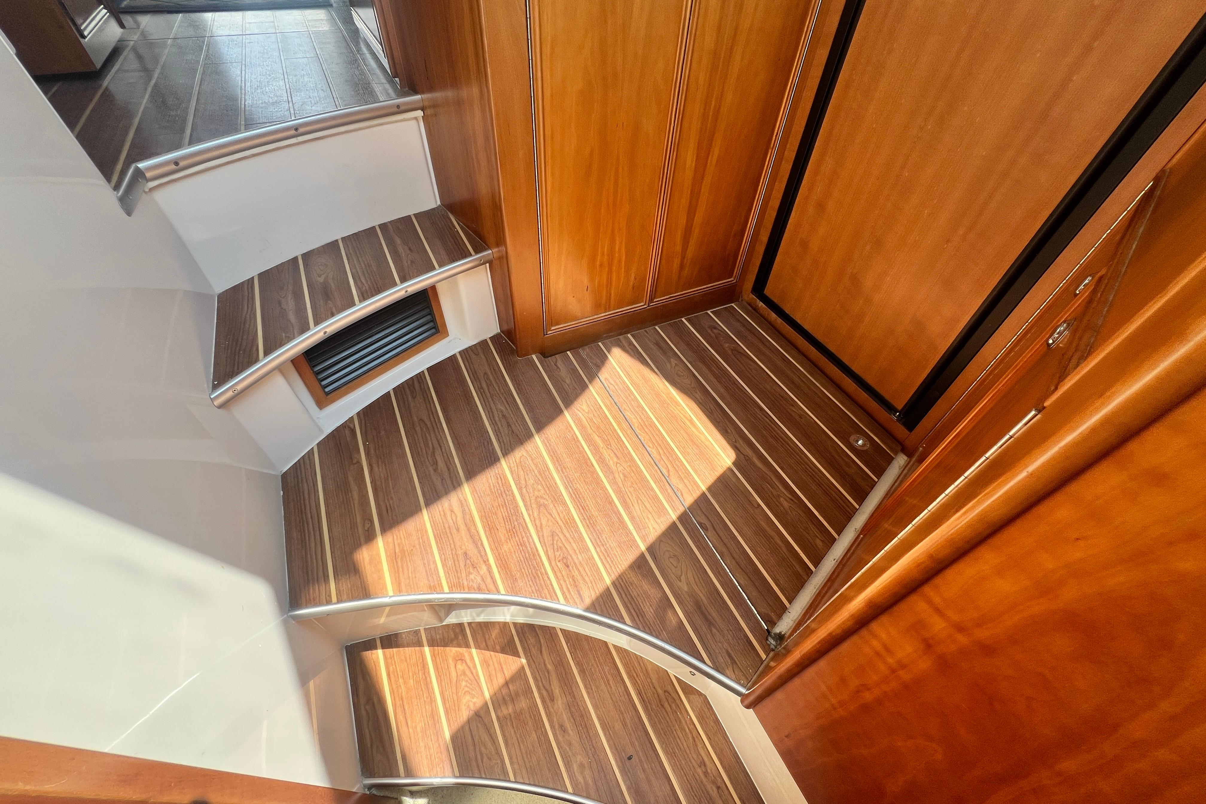 Interior of 2007 Riviera 33 Flybridge with wooden flooring and steps.
