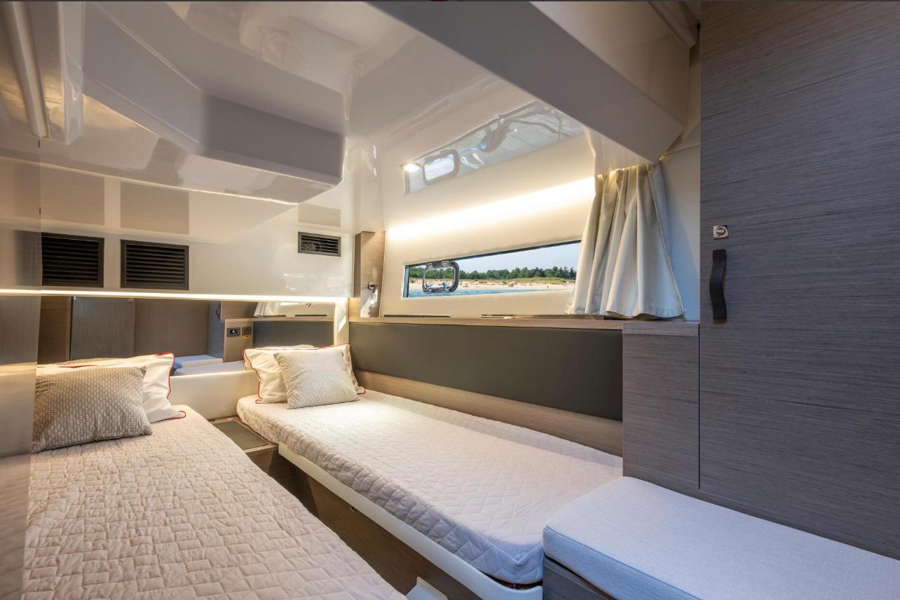 Interior cabin of 2026 Jeanneau NC 1295 Weekender with twin beds and modern design.