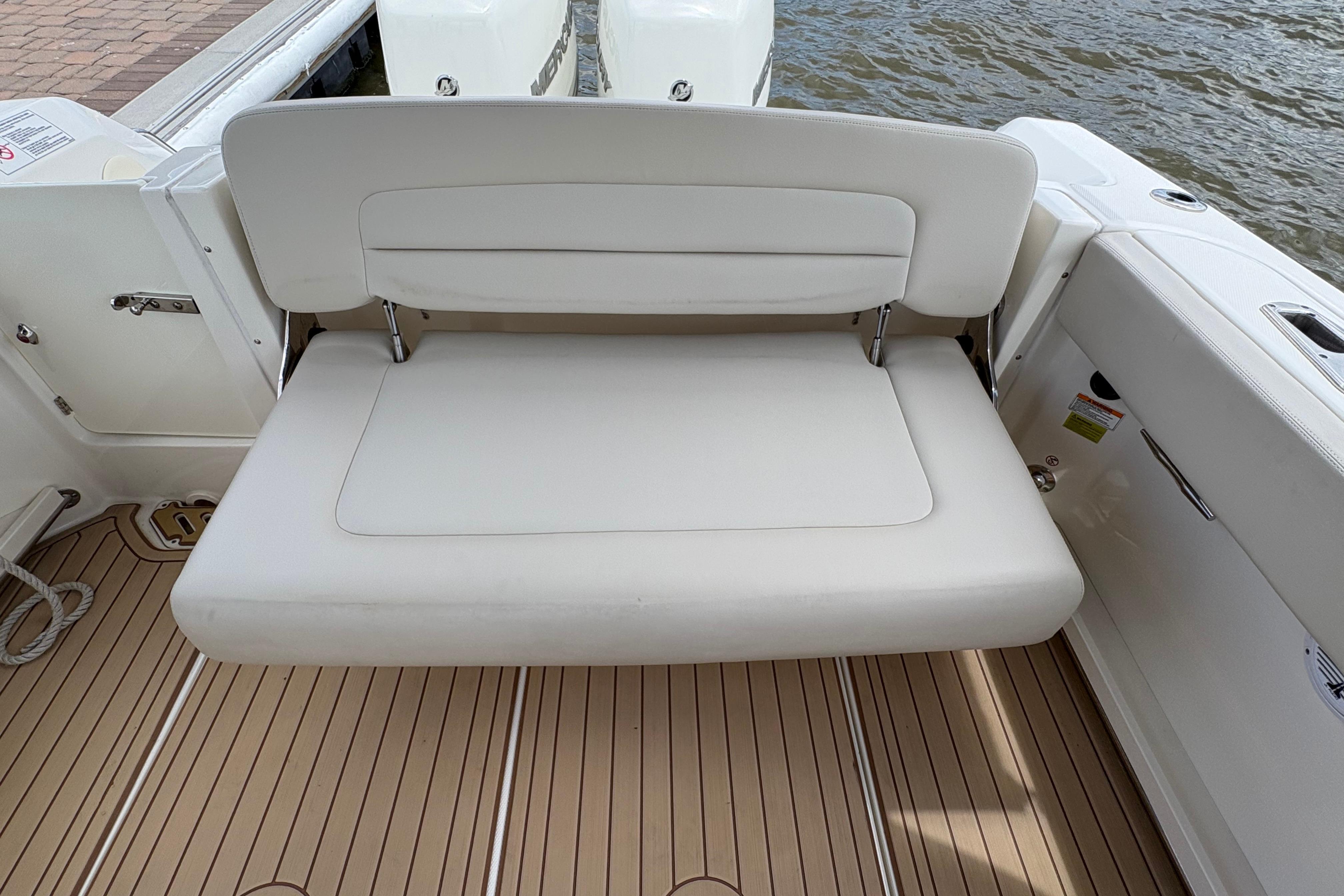 2017 Boston Whaler 270 Vantage boat with white cushioned seating and teak flooring.