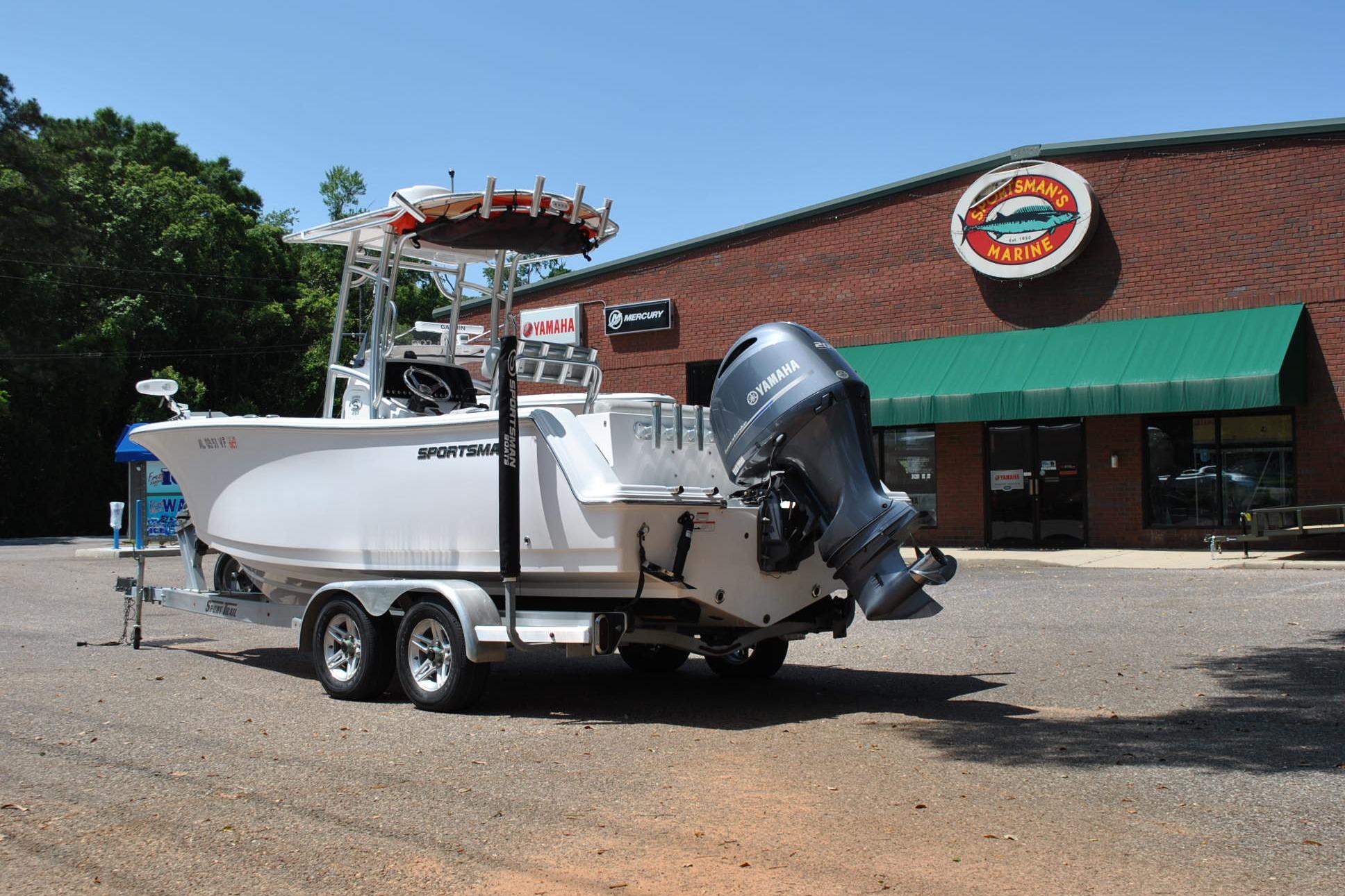 2020 Sportsman Open 232 Center Console boat on trailer outside marine store.