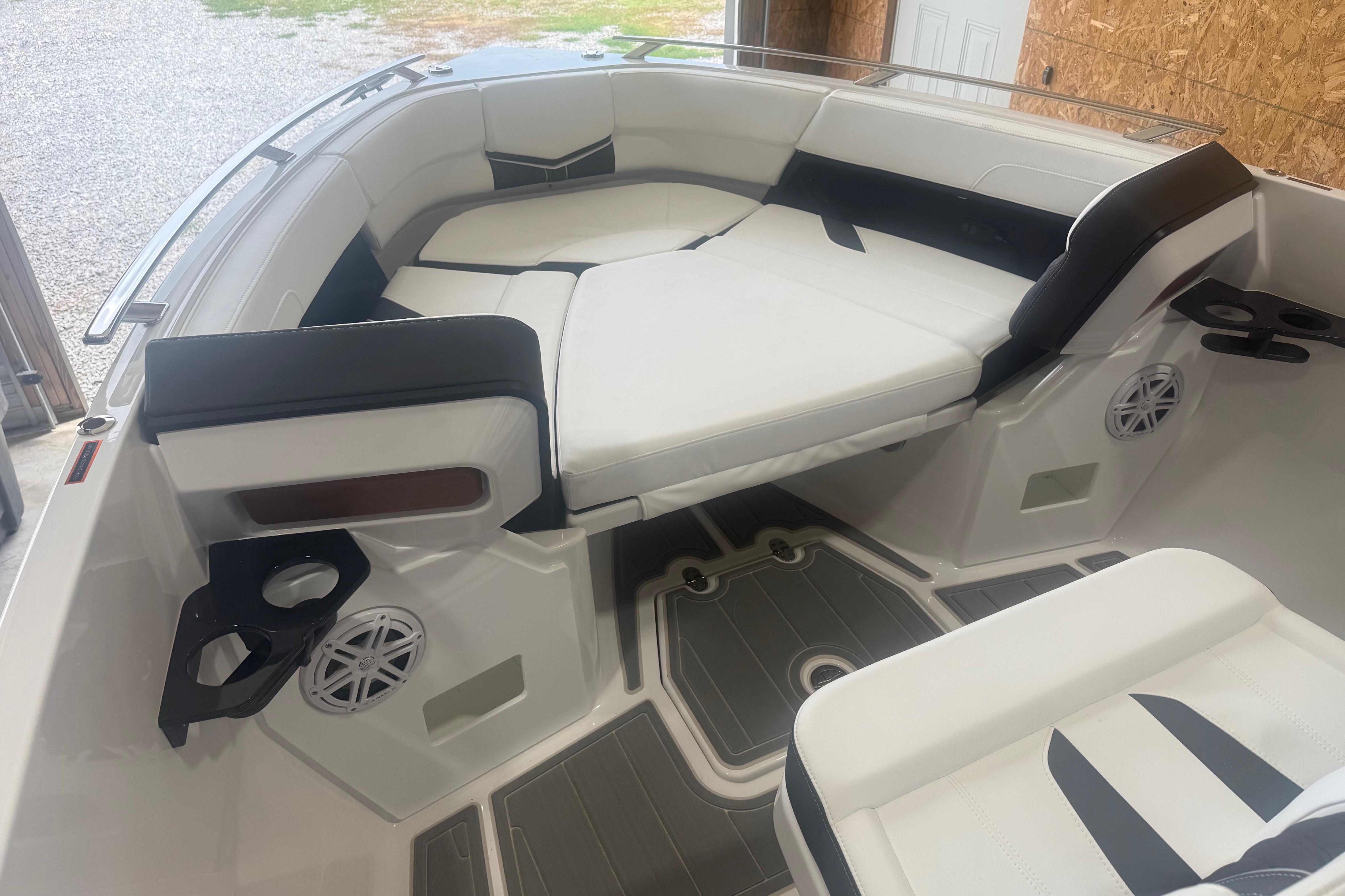 Interior of 2027 Monterey Elite 27 SD boat with white seating and cup holders.